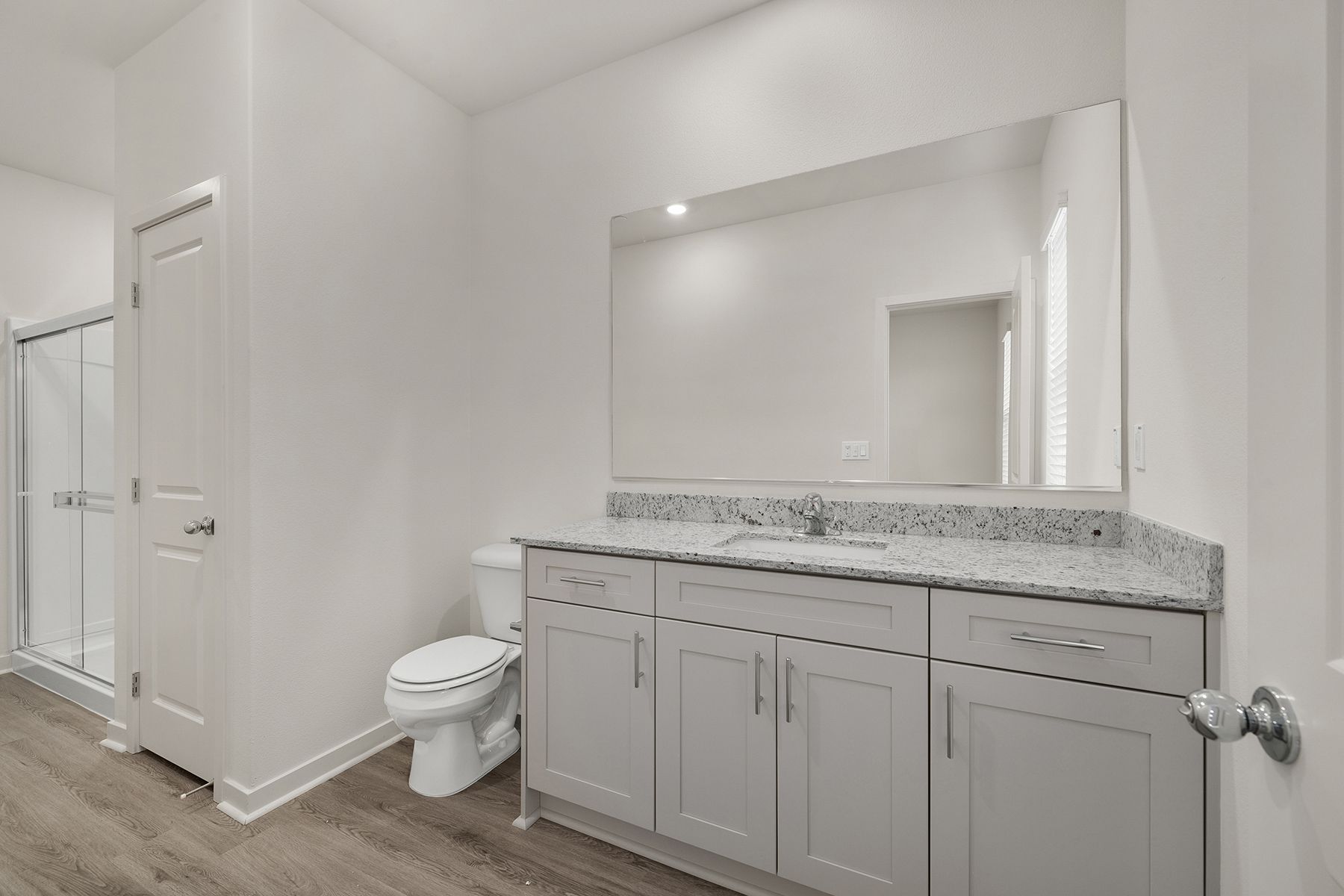 The tertiary bathroom has a step in shower.