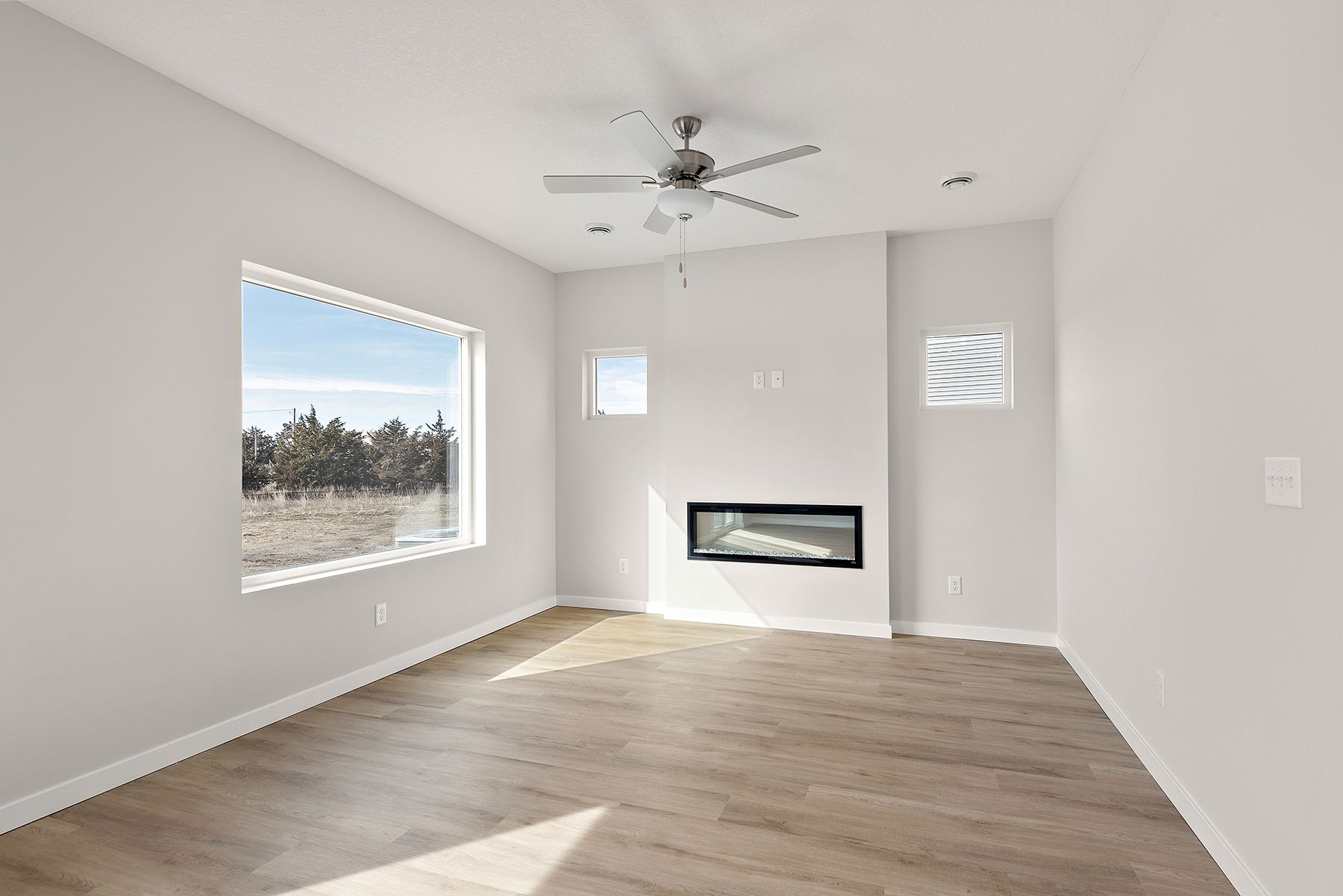 The family room is spacious with a ceiling fan.