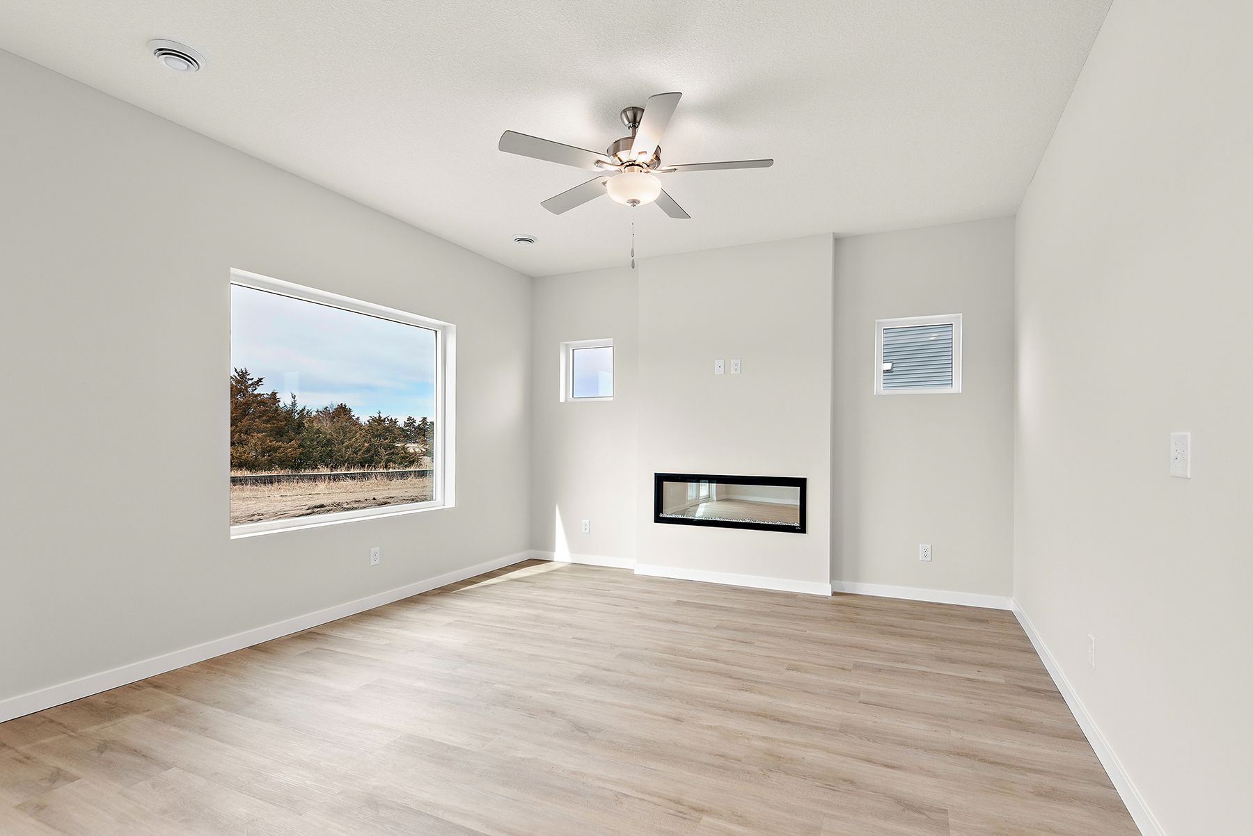 The family room is spacious with a ceiling fan.