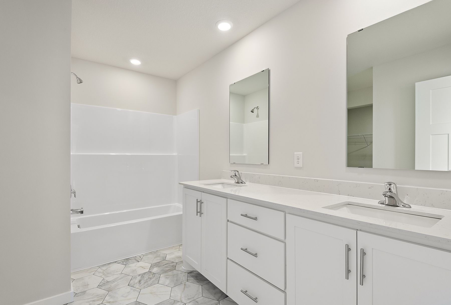 The master bathroom has a dual sink vanity and a tub/shower combo.