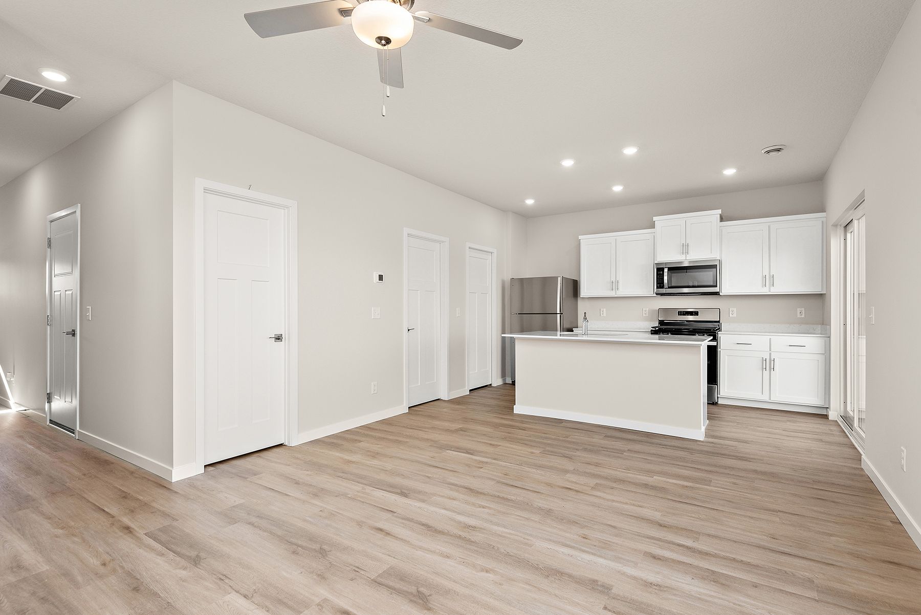 The family room is spacious with a ceiling fan.