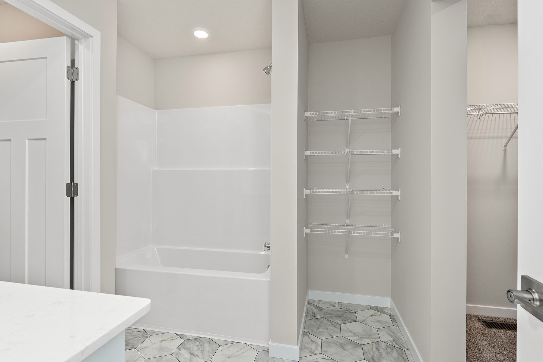 The master bathroom has a large vanity with a tub/shower combo.