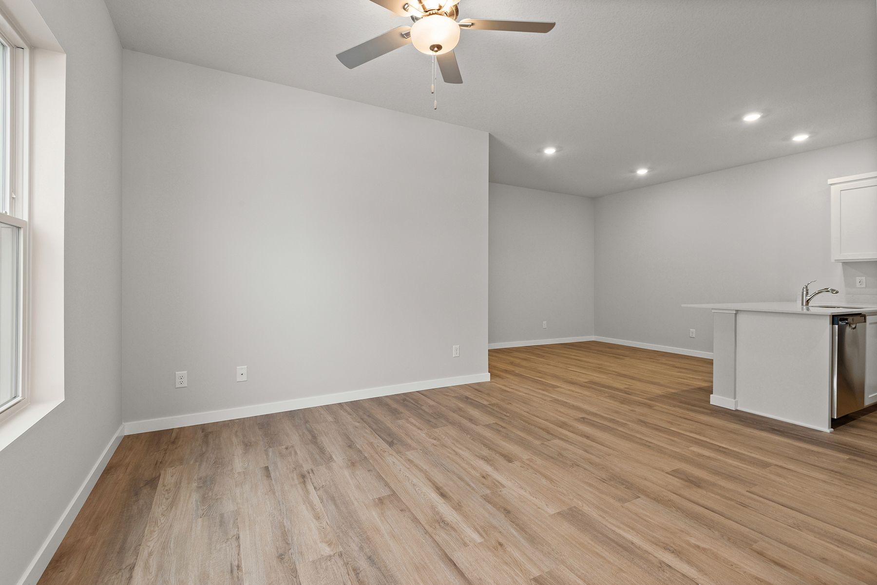 The family room is spacious with a ceiling fan.
