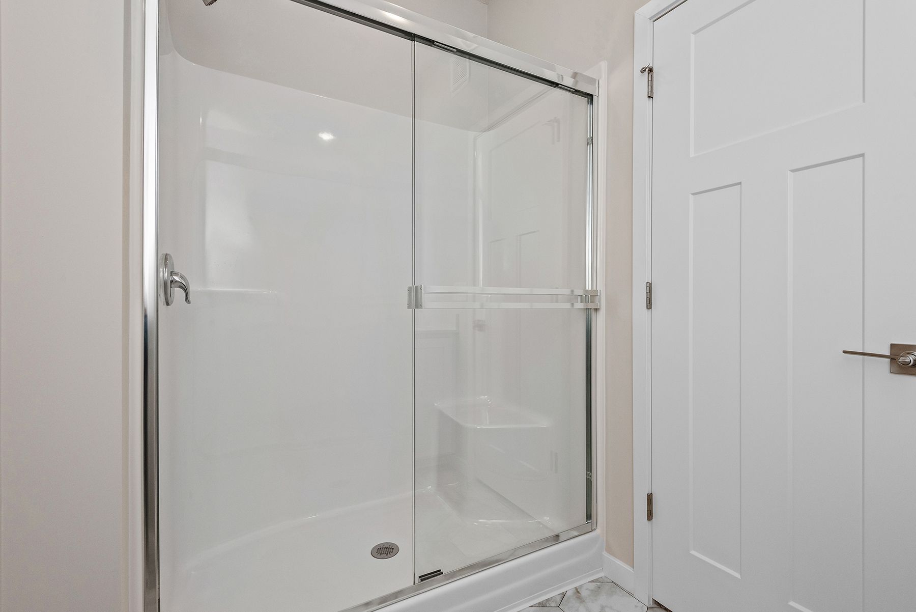 The master bathroom has a large vanity and a step in shower,