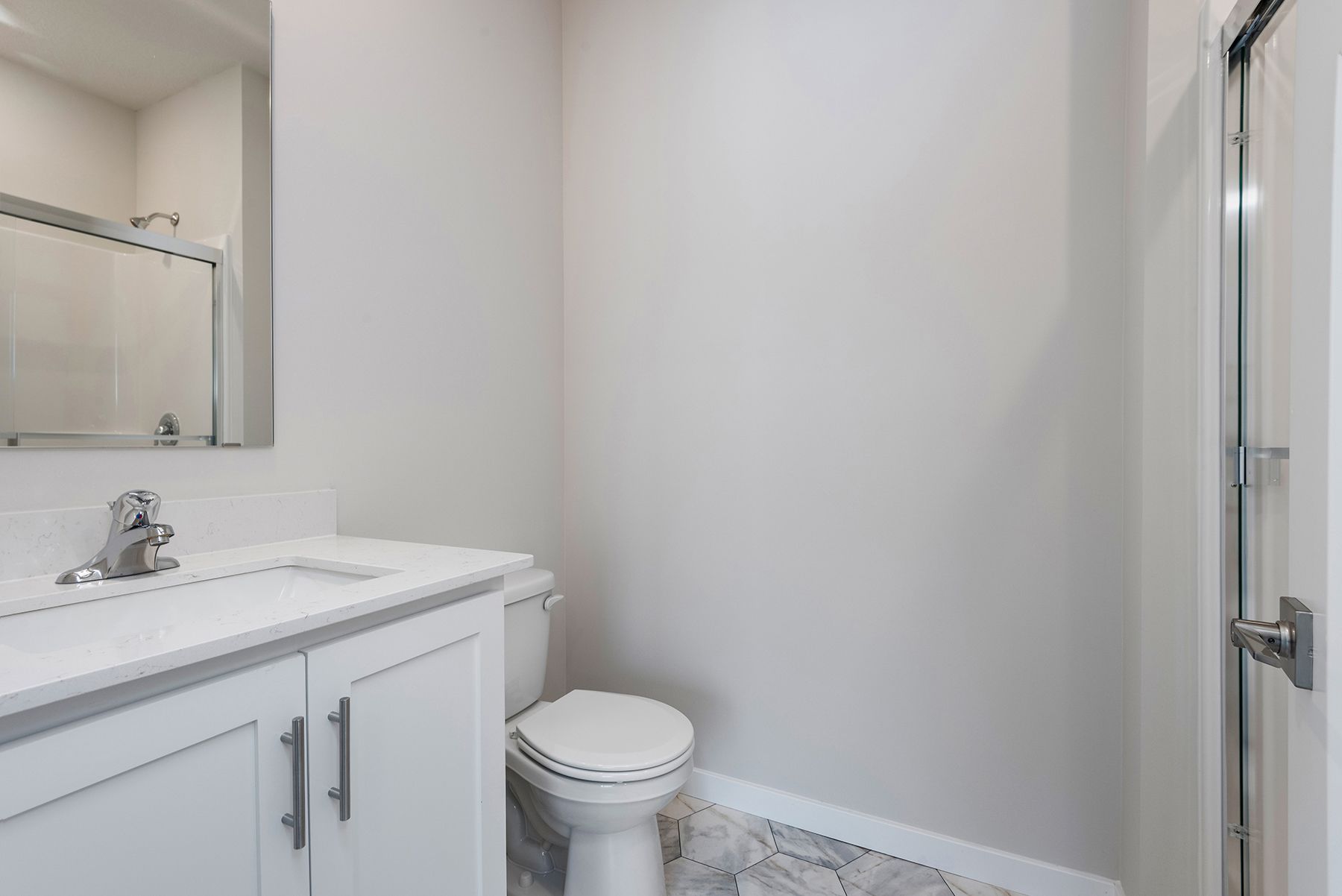 The master bathroom has a large vanity and a step in shower,