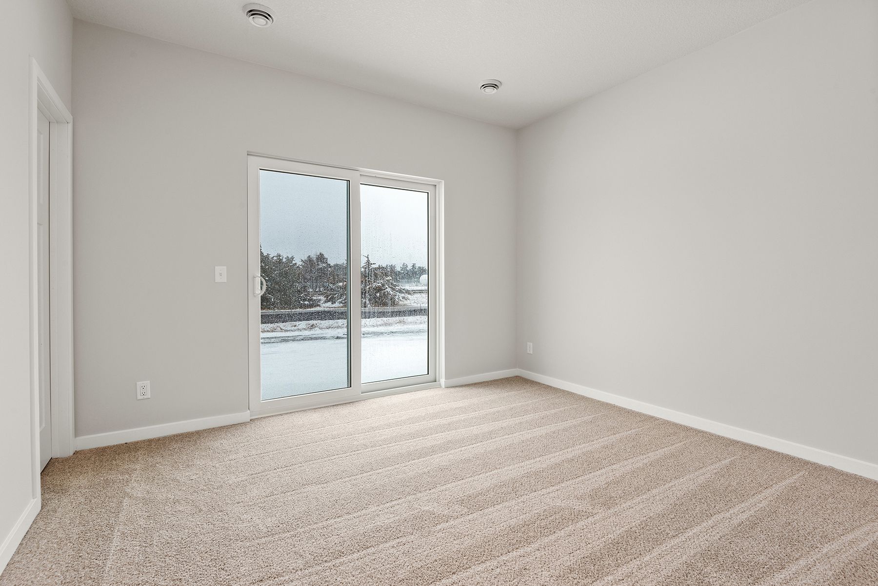 The master bedroom is spacious and has carpet.