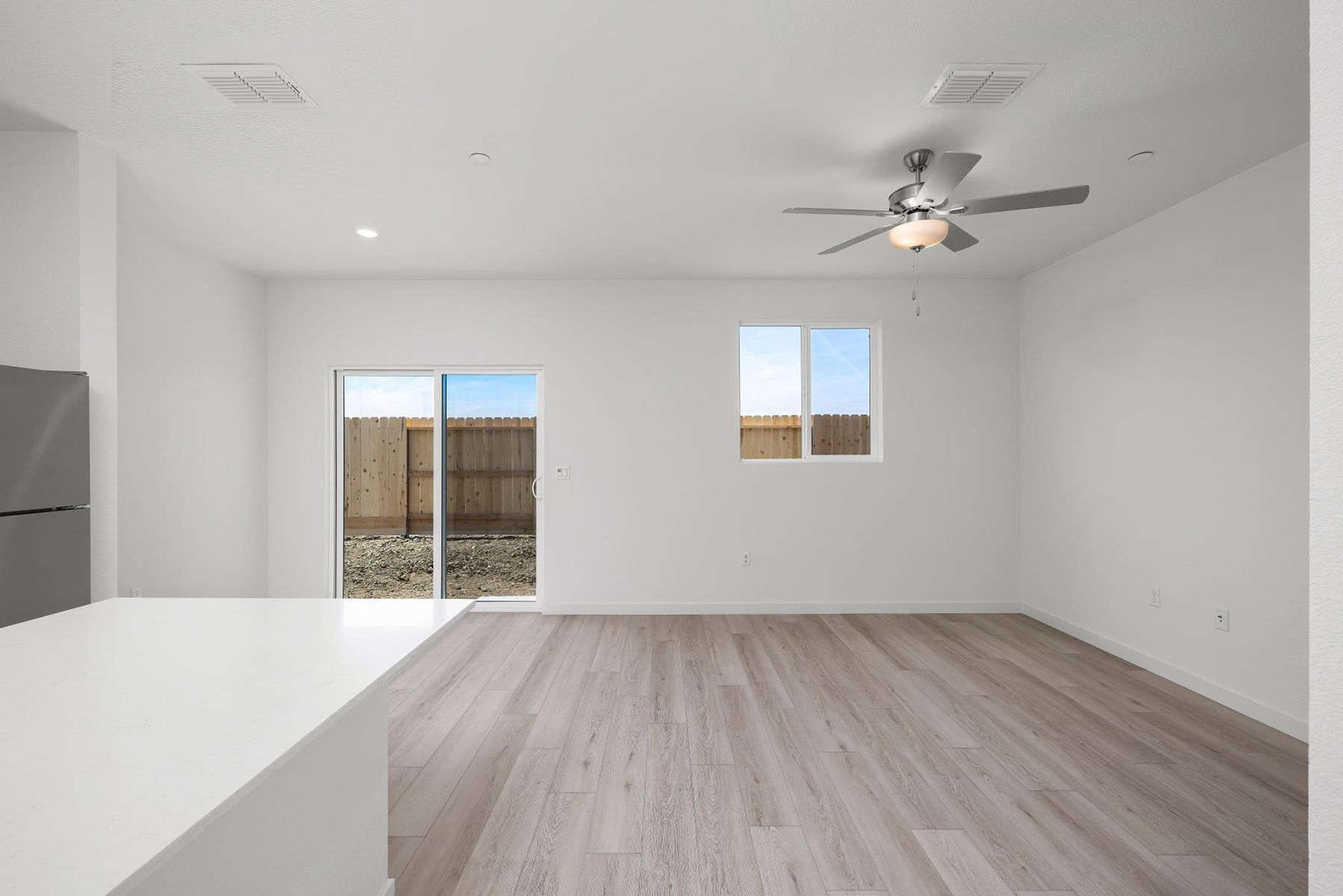 The family room is spacious with a ceiling fan.