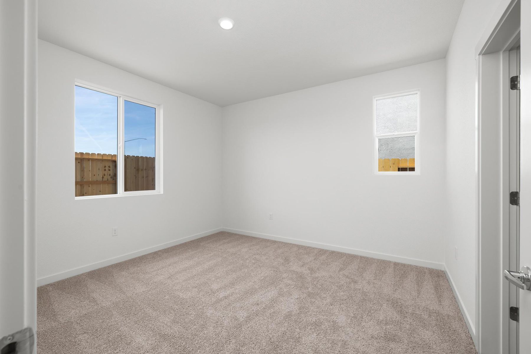 The master bedroom is spacious and has carpet.