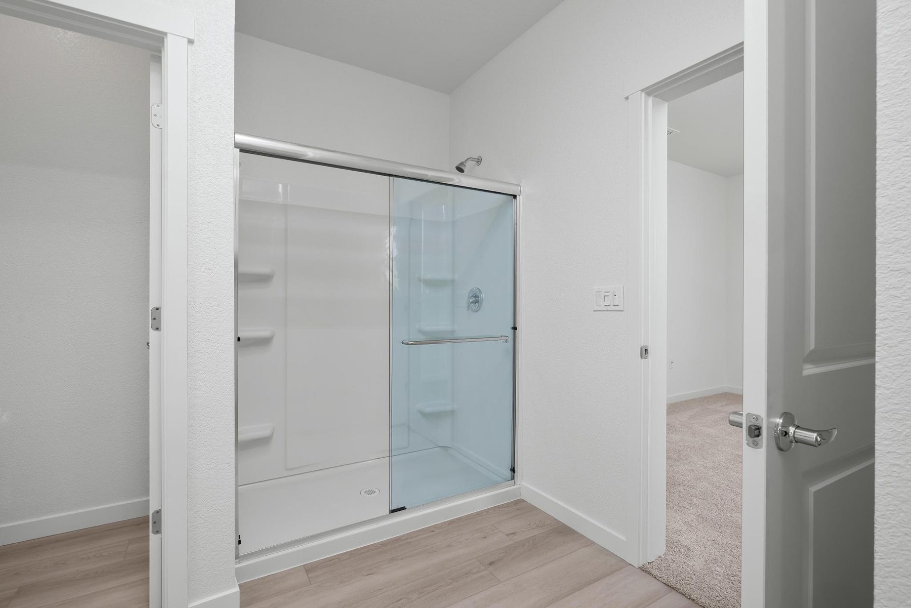 The master bathroom has a large vanity and a step in shower.