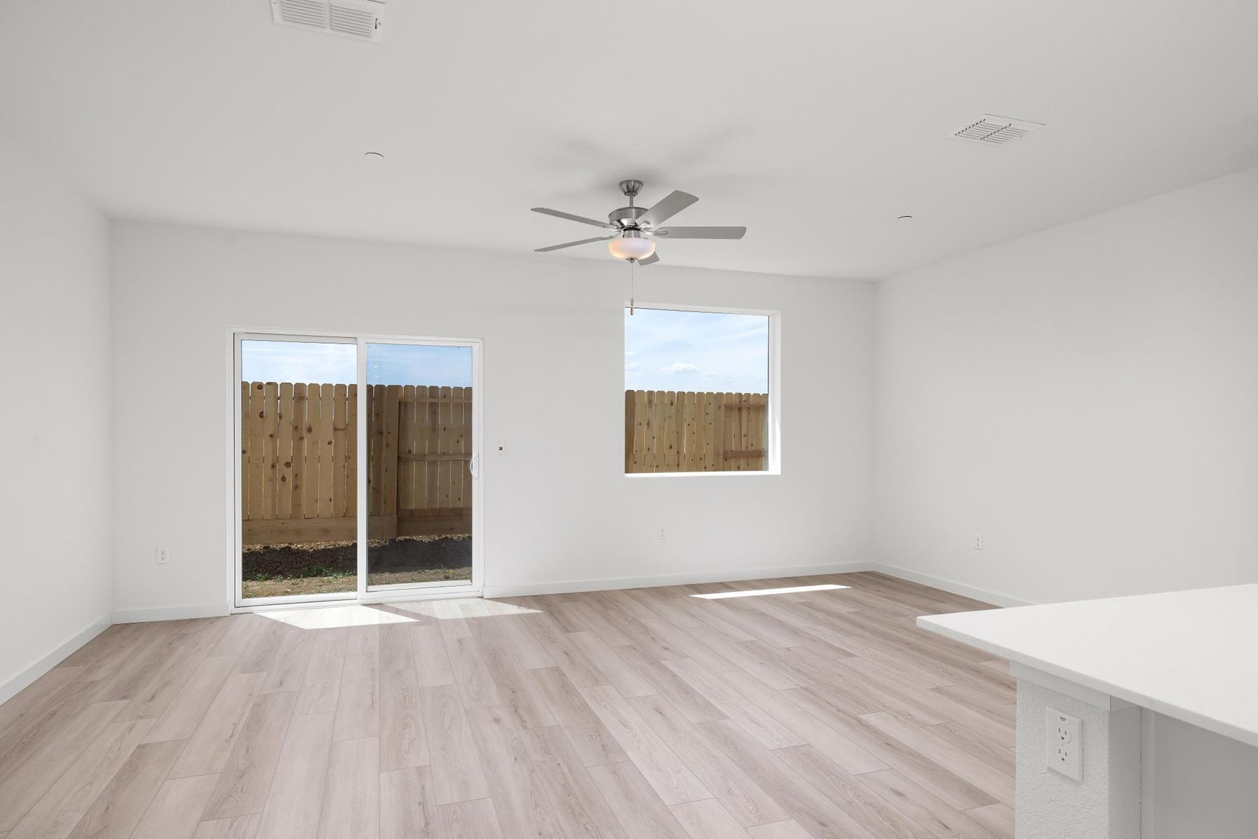 The family room is spacious with a ceiling fan.