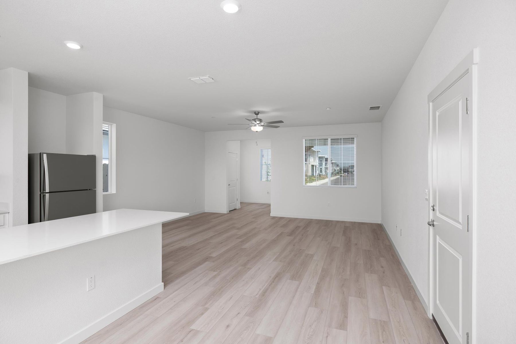 The family room is spacious with a ceiling fan.