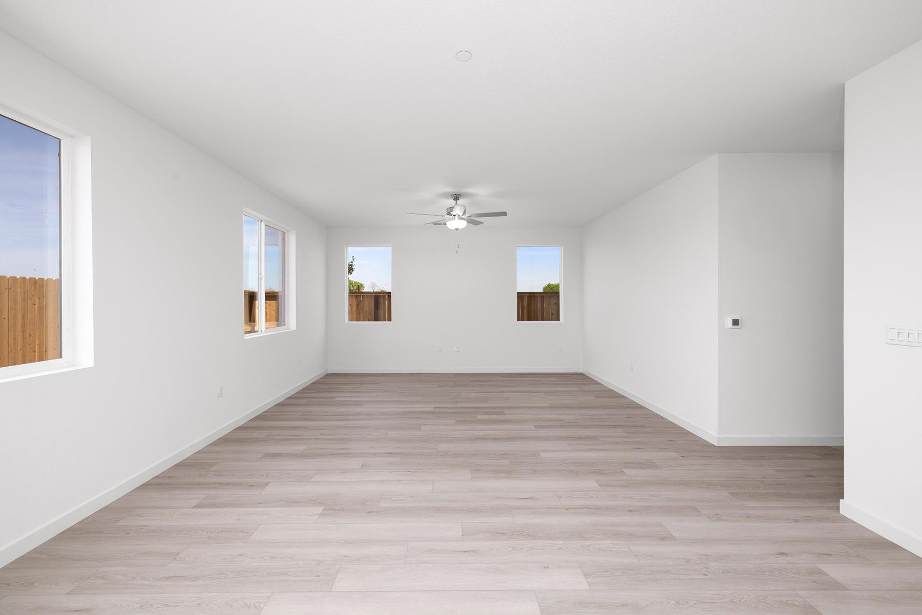 The family room is spacious with a ceiling fan.
