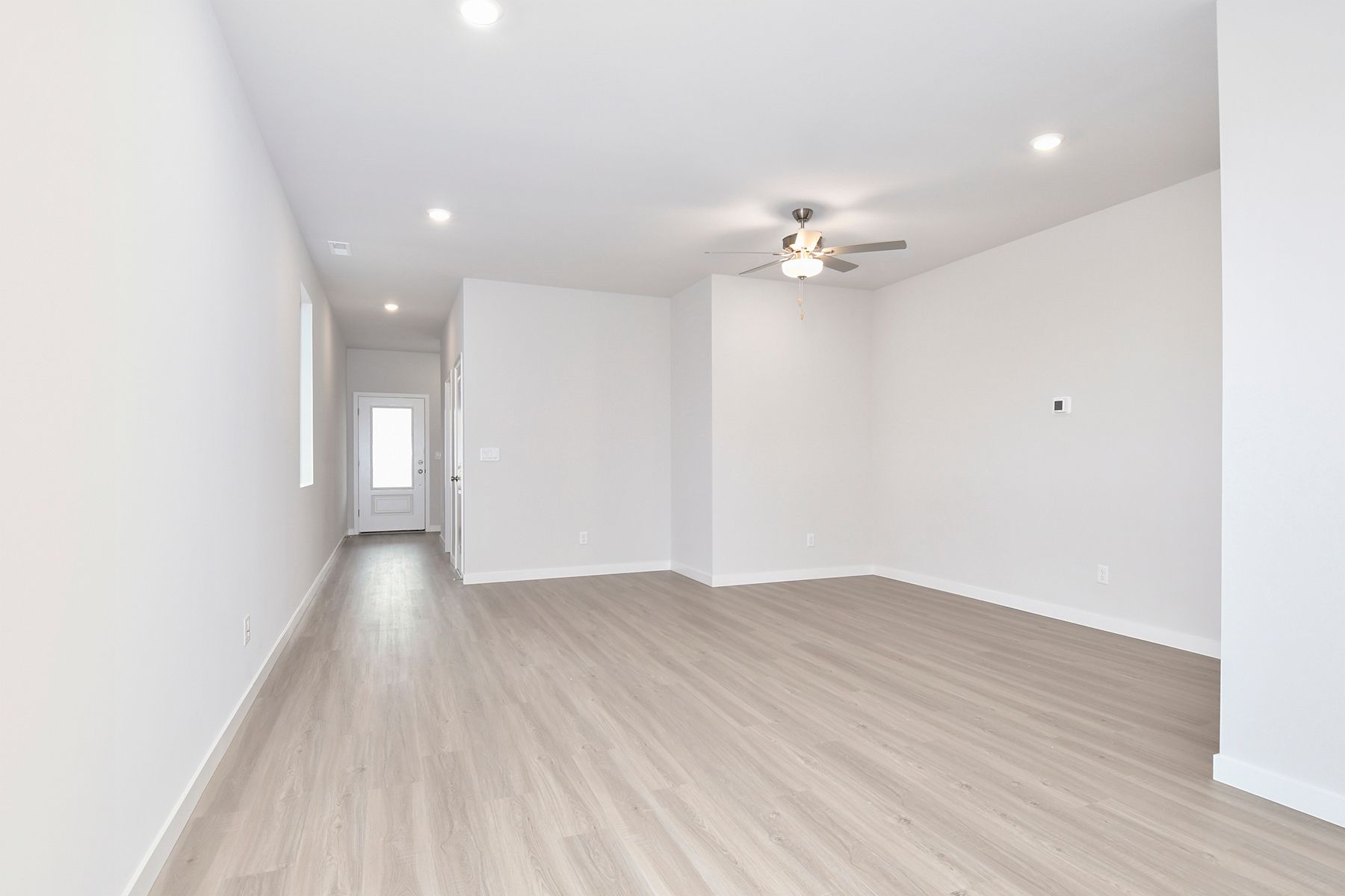 The family room is spacious with a ceiling fan.
