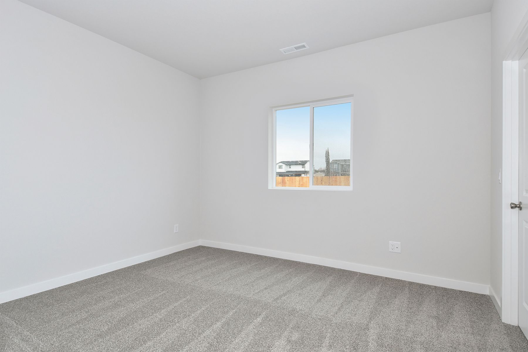 The master bedroom is spacious and has carpet.