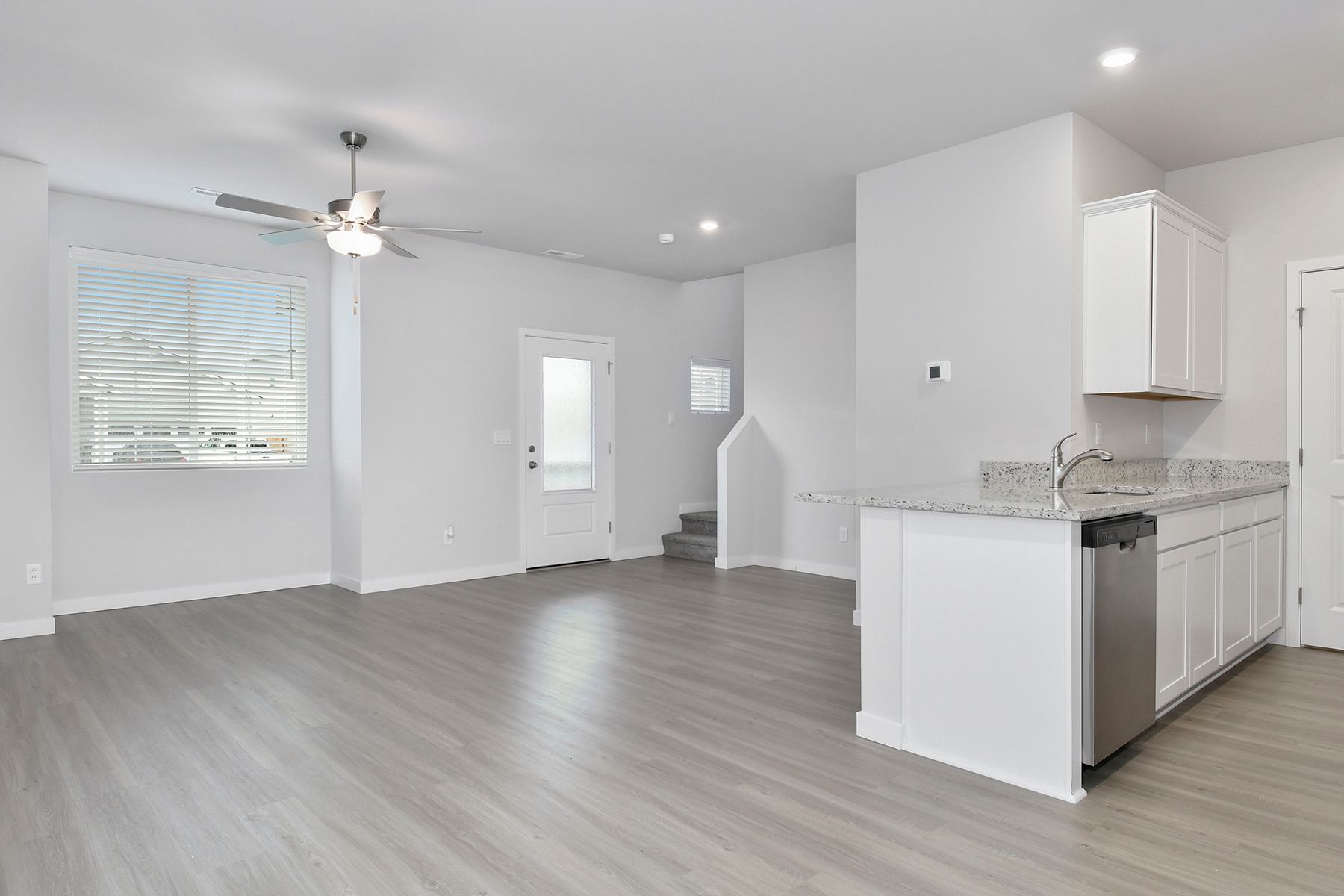 The family room is spacious with a ceiling fan.