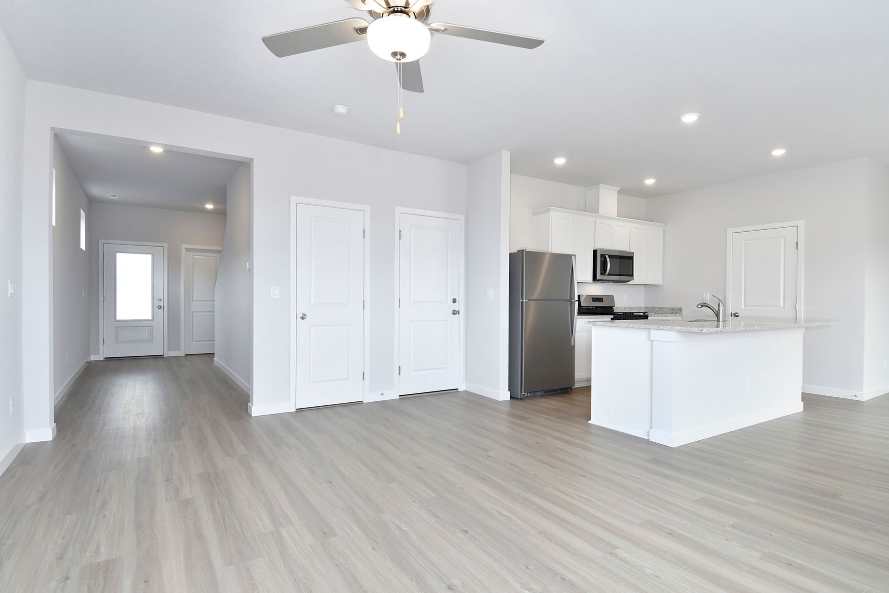 The family room is spacious with a ceiling fan.