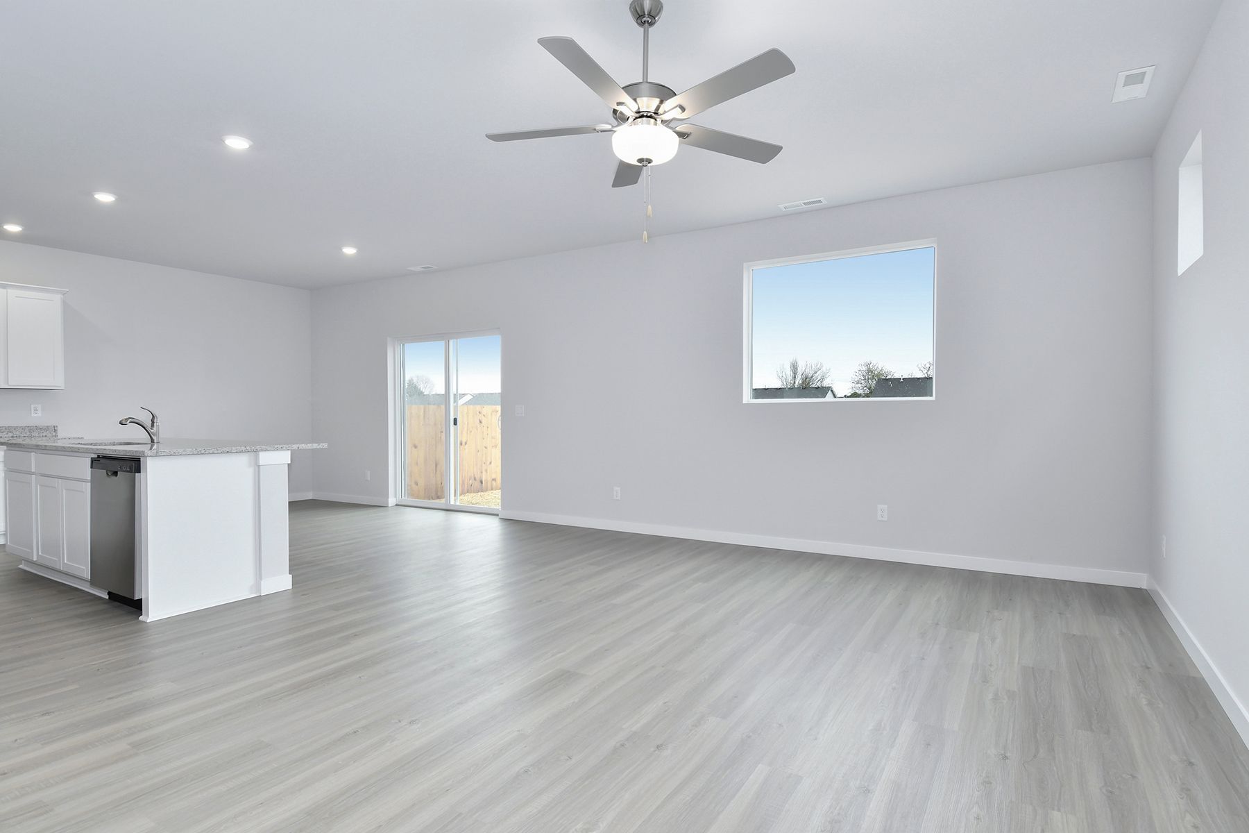 The family room is spacious with a ceiling fan.