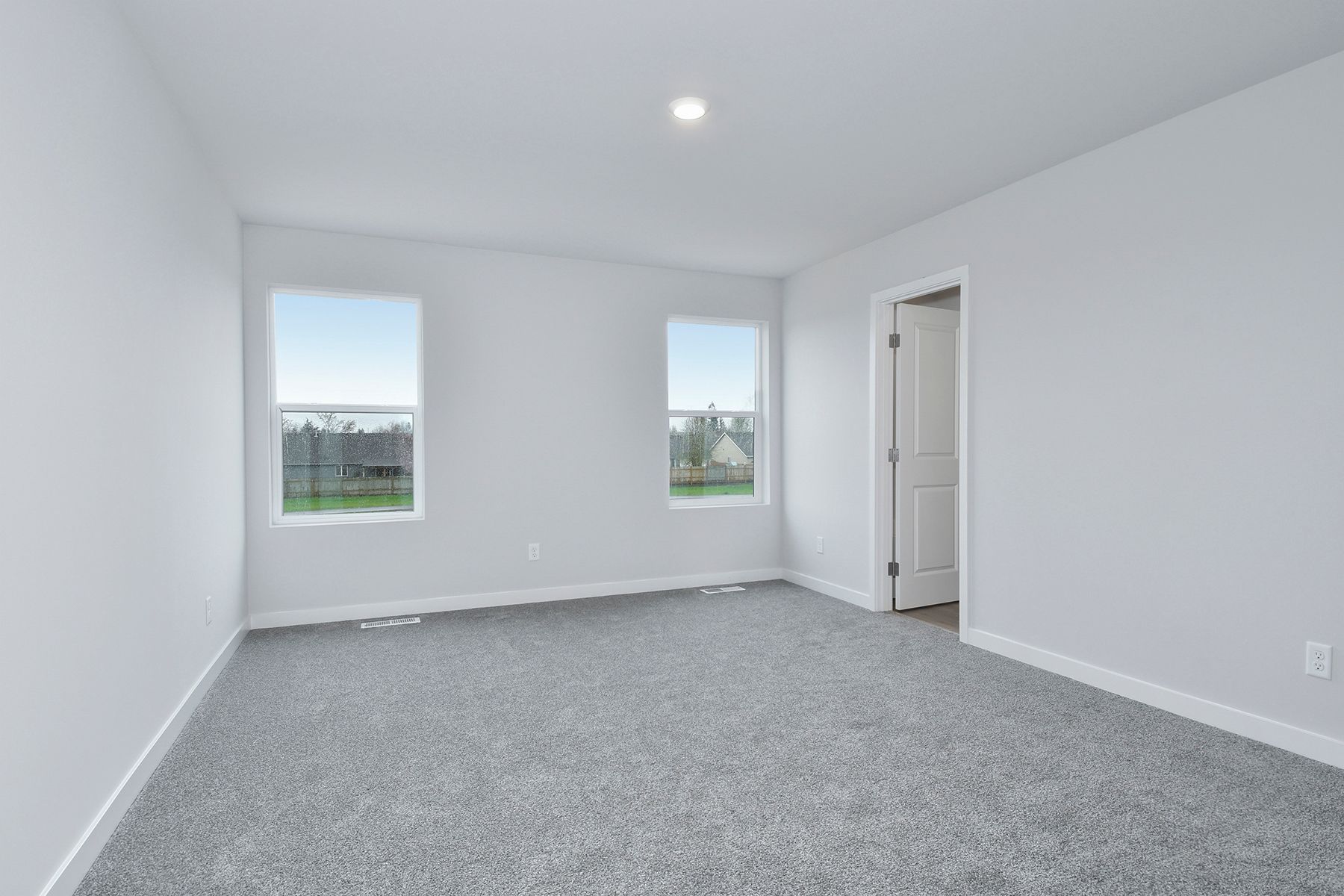 The master bedroom is spacious and has carpet.