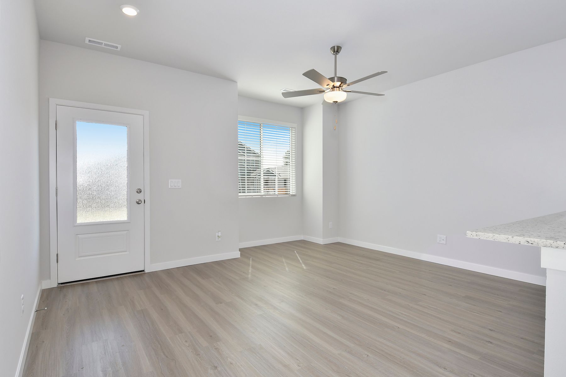 The family room is spacious with a ceiling fan.