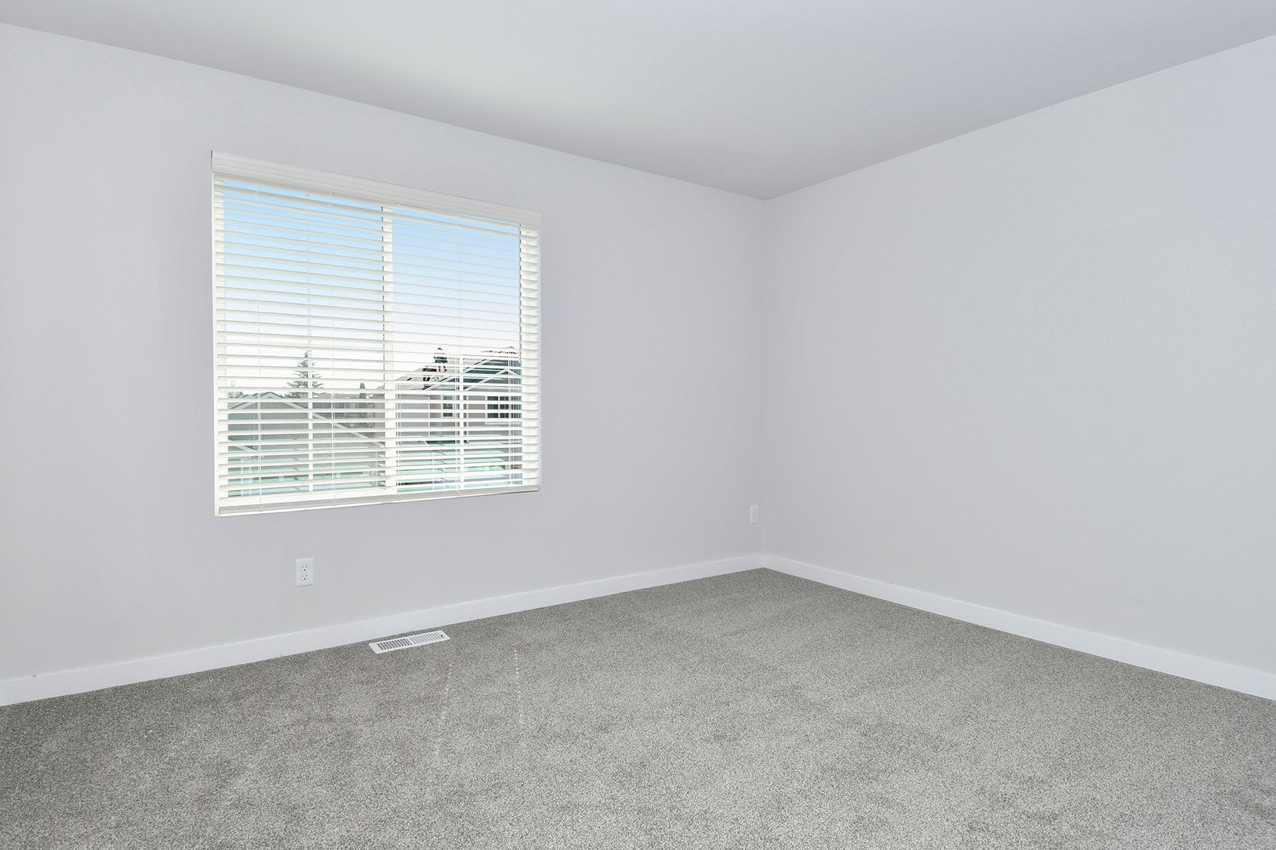The master bedroom is spacious and has carpet.