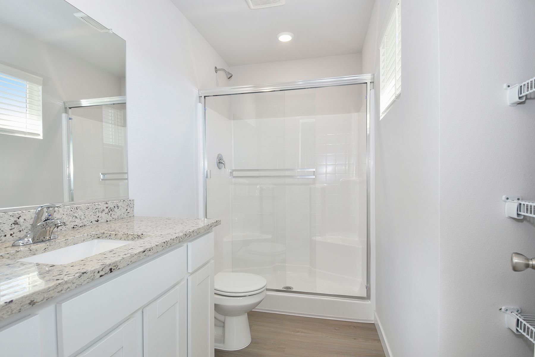 The master bathroom has a large vanity with a step in shower.