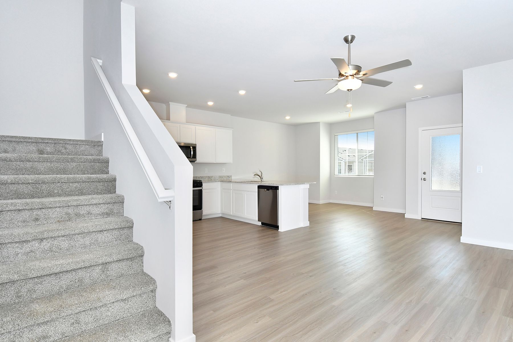 The family room is spacious with a ceiling fan.