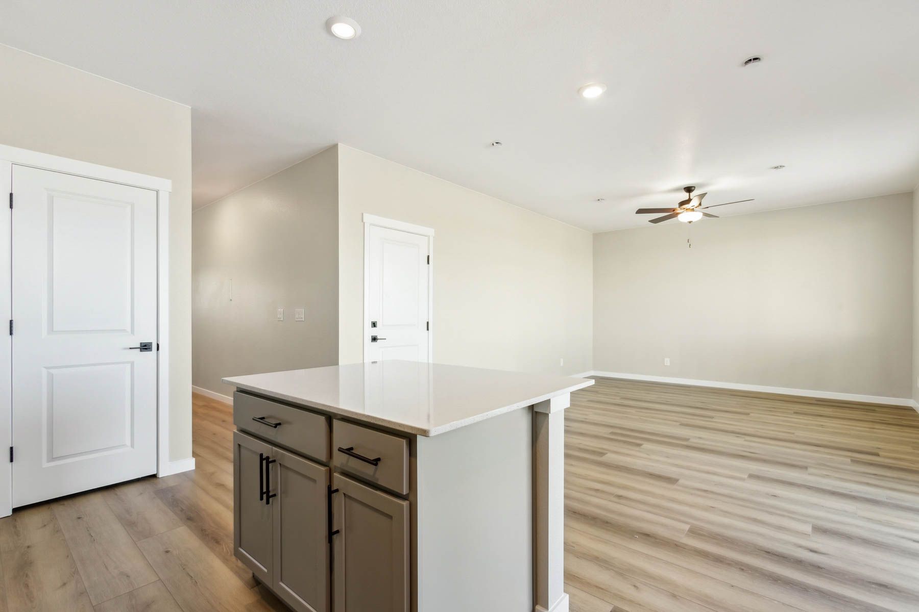 The family room is spacious with a ceiling fan.