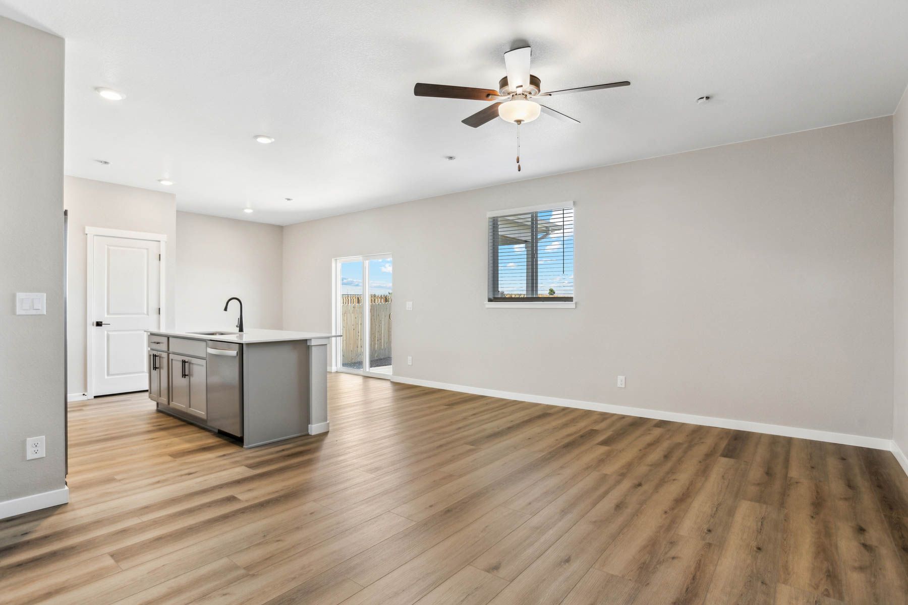 The family room is spacious with a ceiling fan.