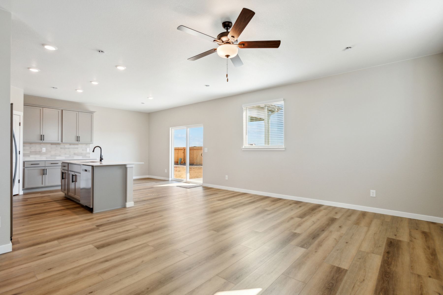 The family room is spacious with a ceiling fan.