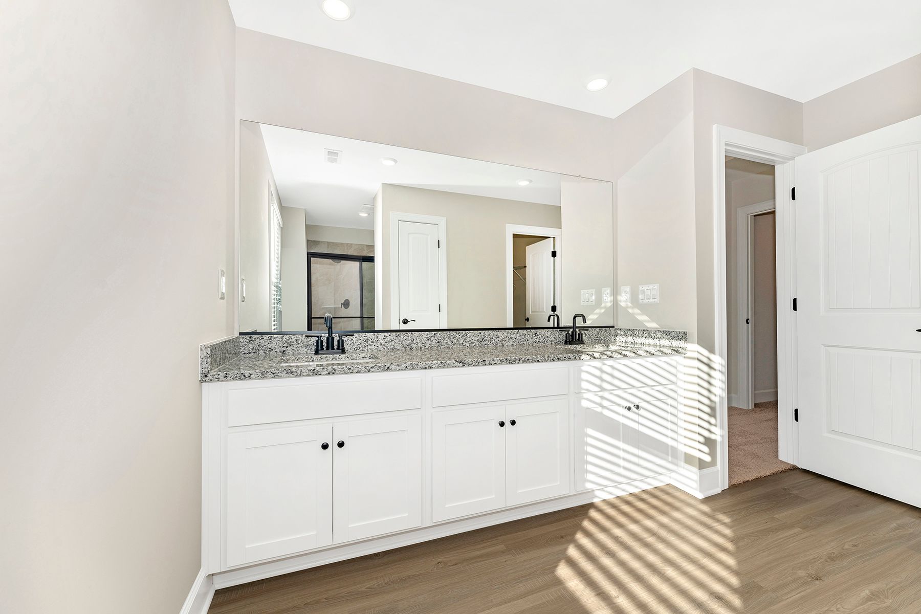 The master bathroom has a glass-enclosed shower