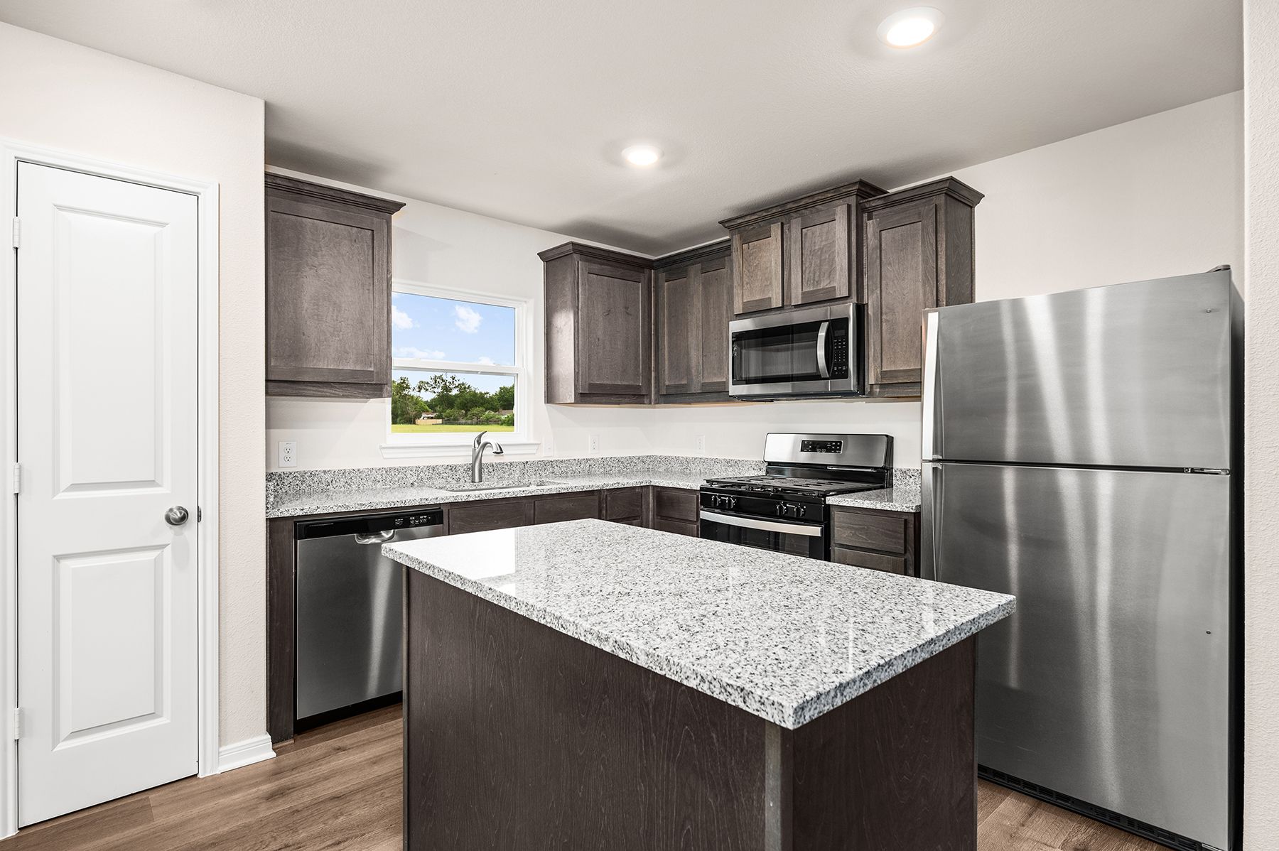 The kitchen has beautiful wood cabinetry.