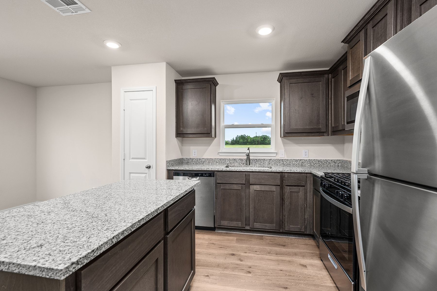 The kitchen has a large window over the sink.