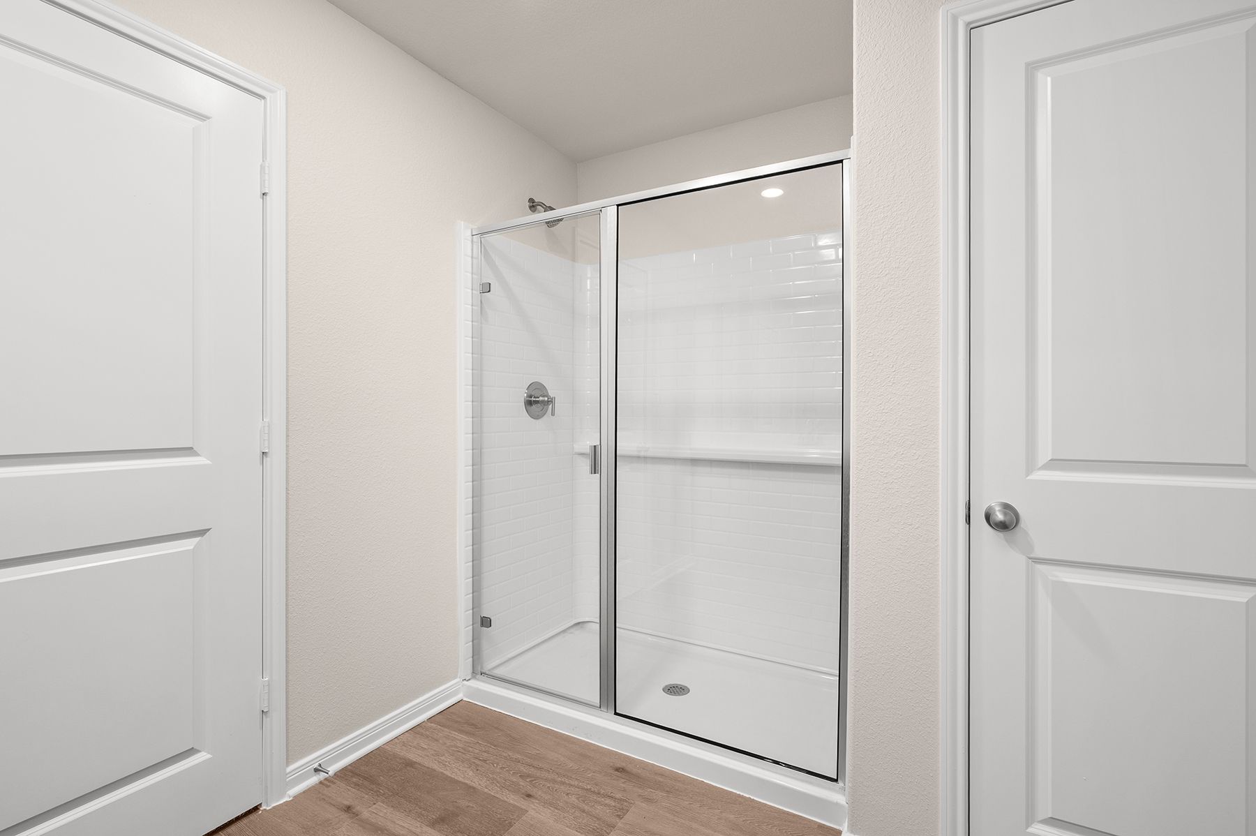 The master bathroom has a glass, walk-in shower.
