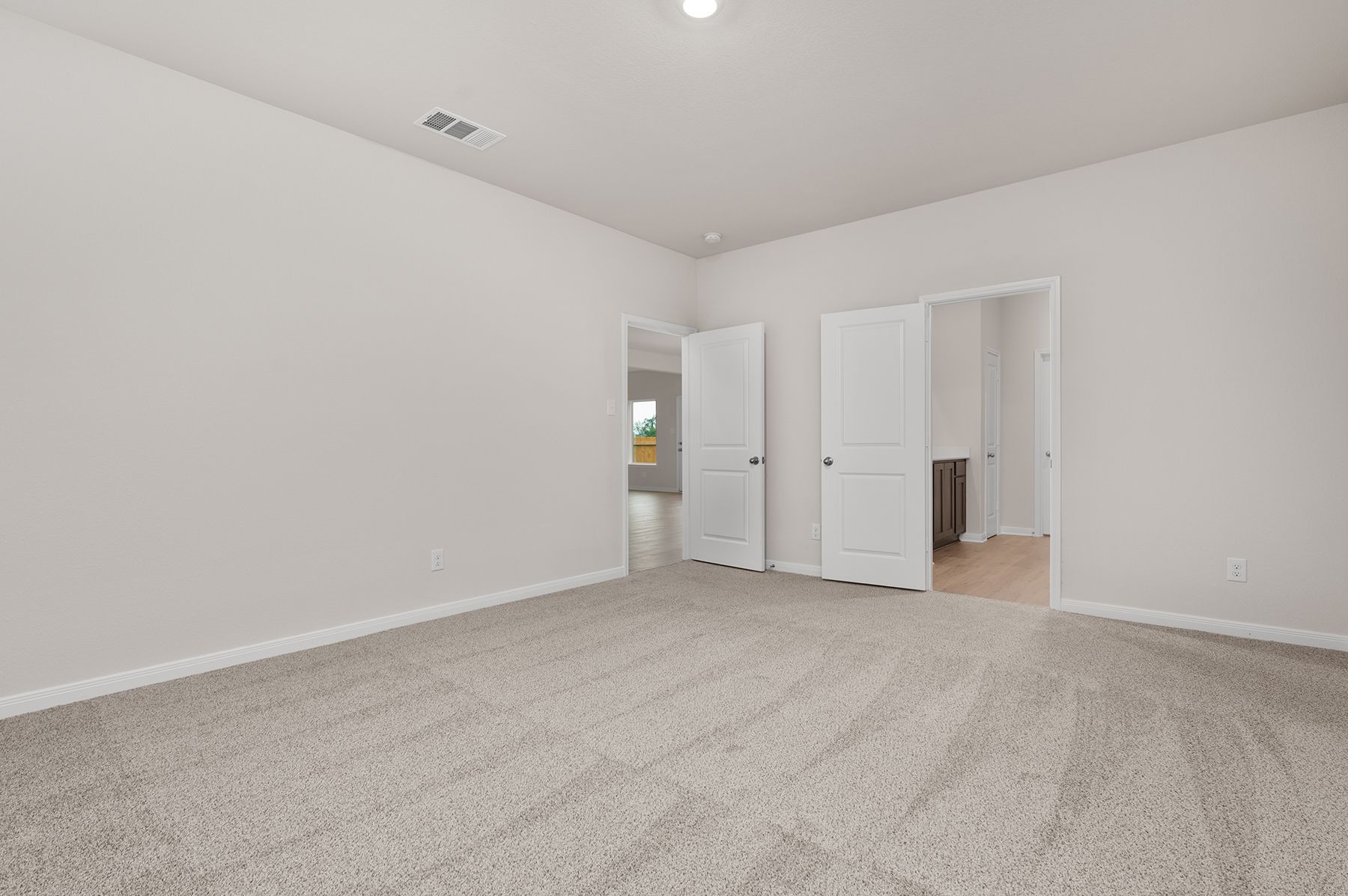 The master suite has a large bedroom, ensuite bathroom and a walk-in closet.