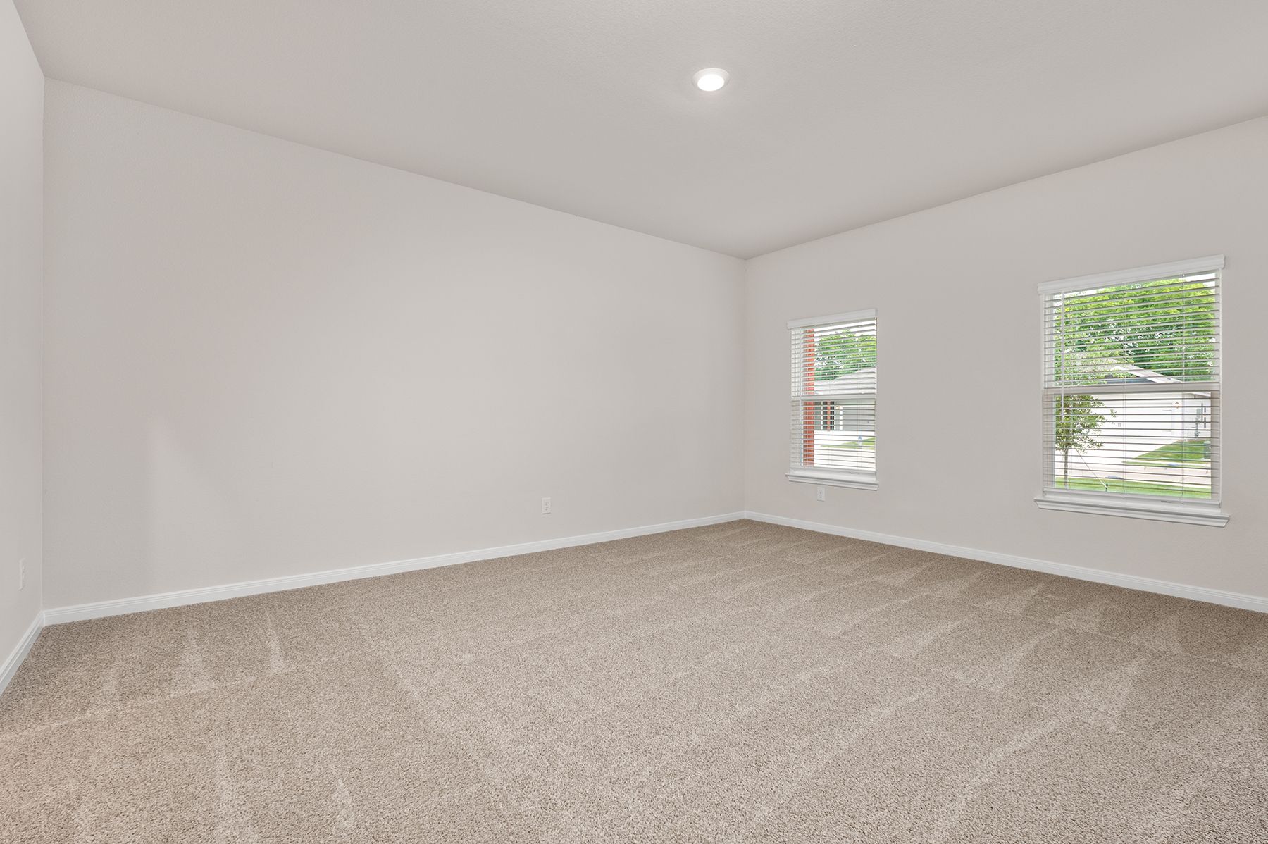 The master bedroom has two large windows.