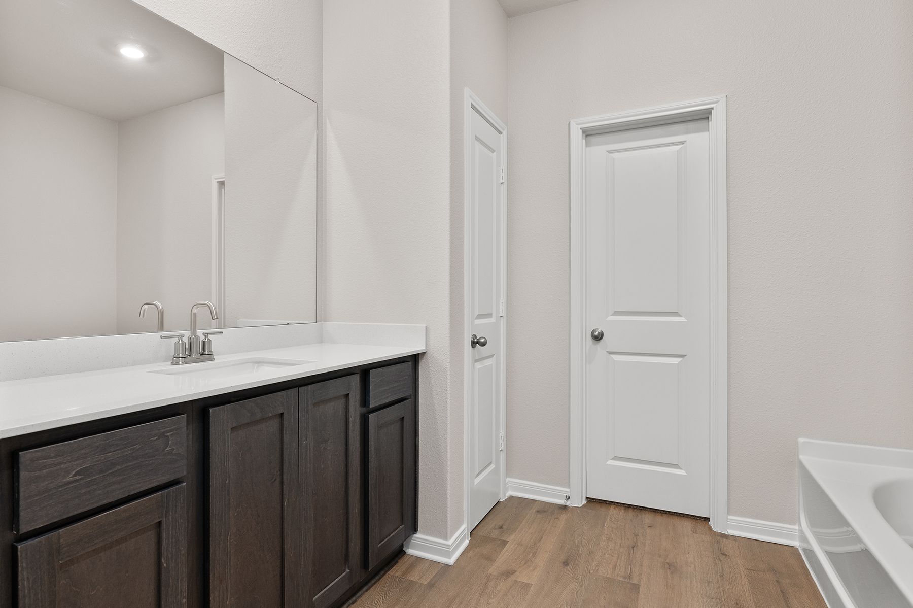 The master bathroom has a large vanity space.
