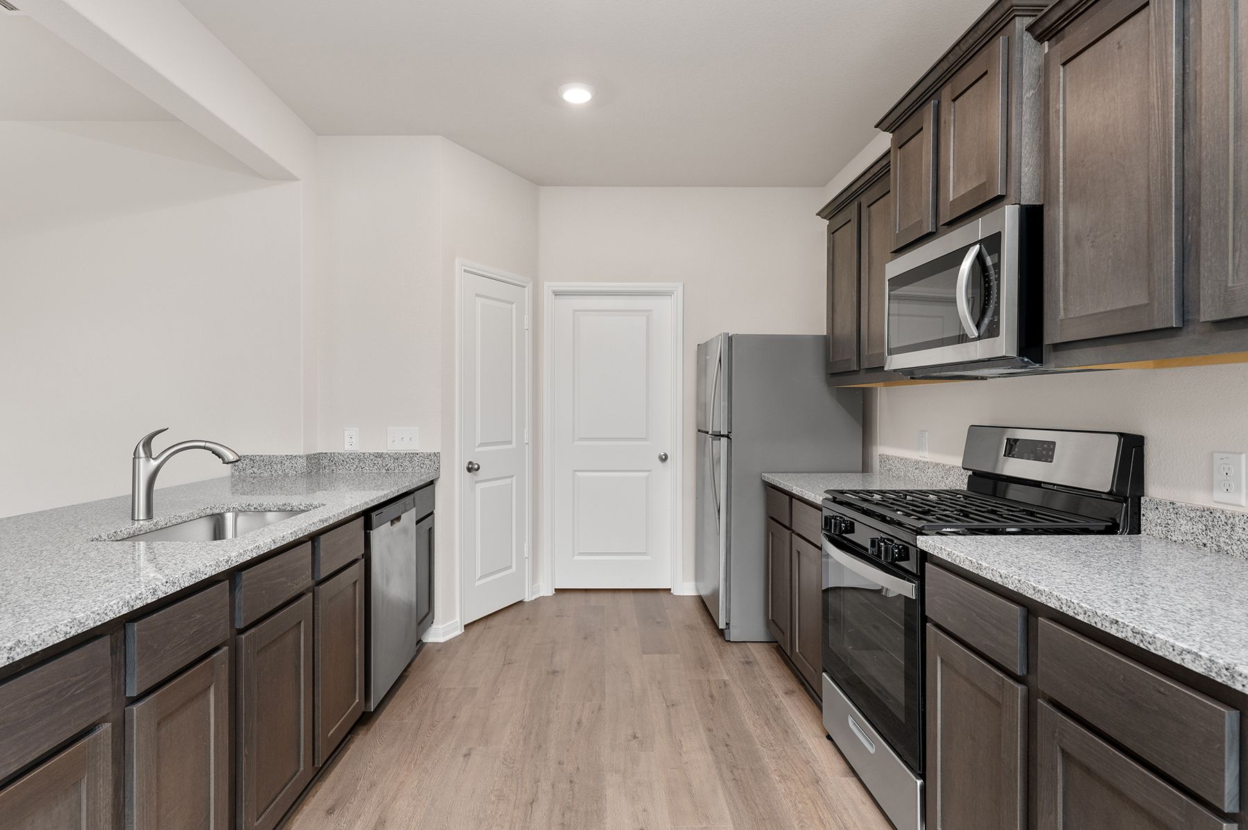 The kitchen of the Cypress has gorgeous wood cabinetry.