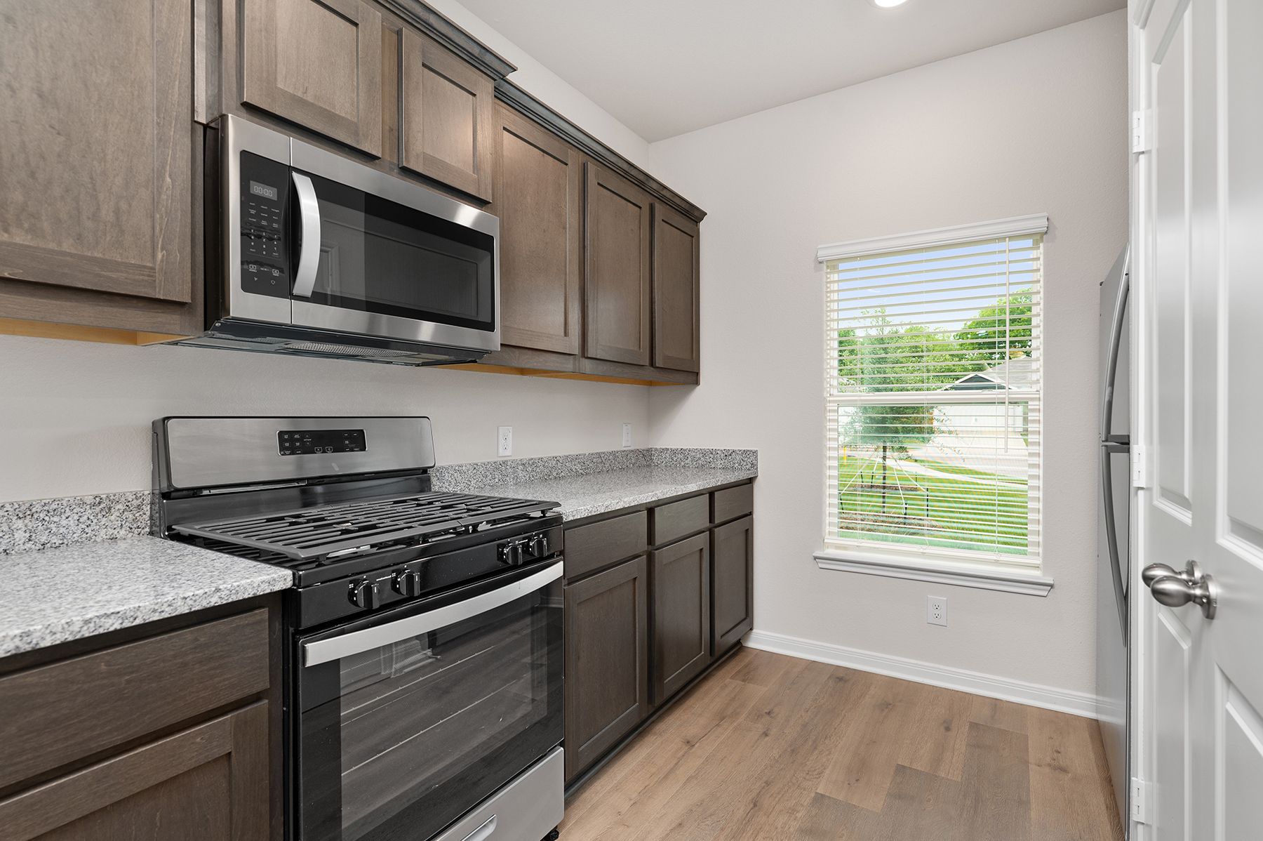 The kitchen of the Driftwood has beautiful wood cabinetry.