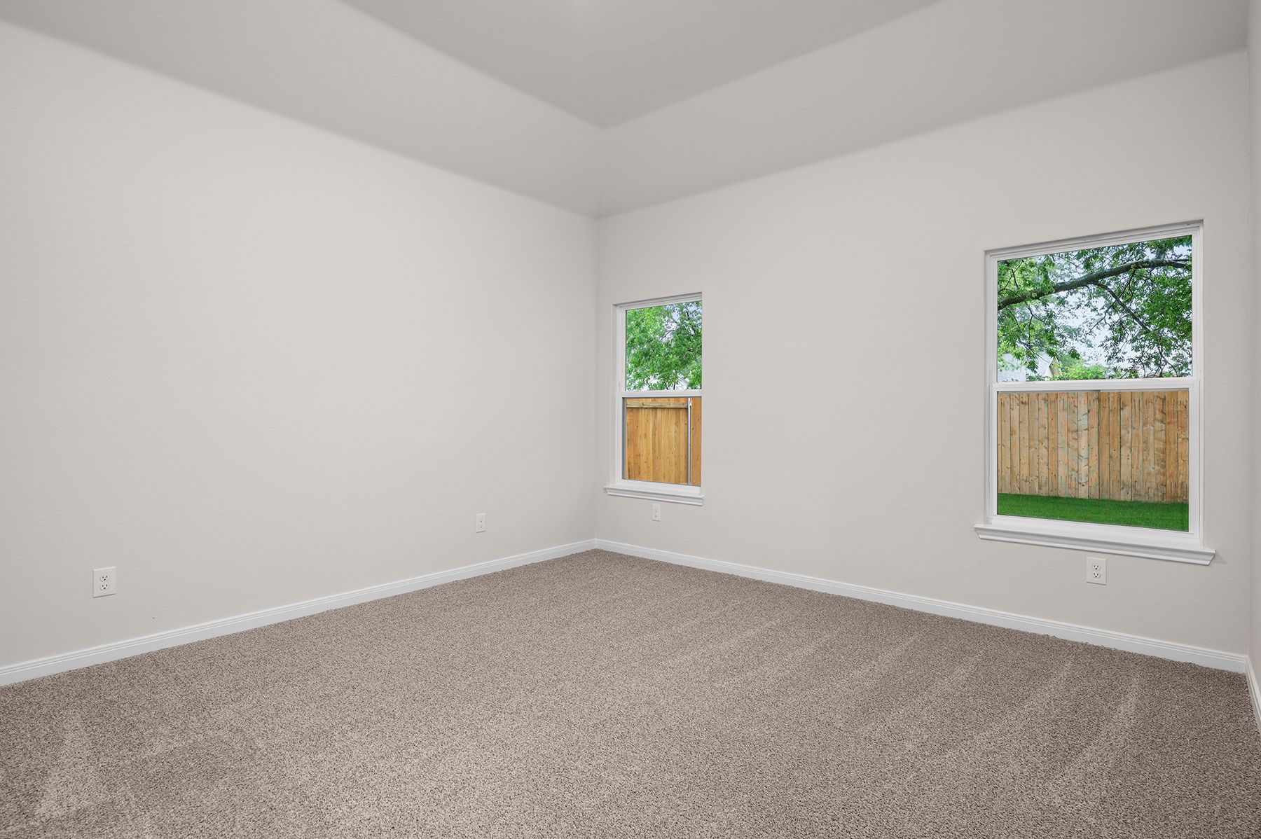 The master bedroom has two large windows.