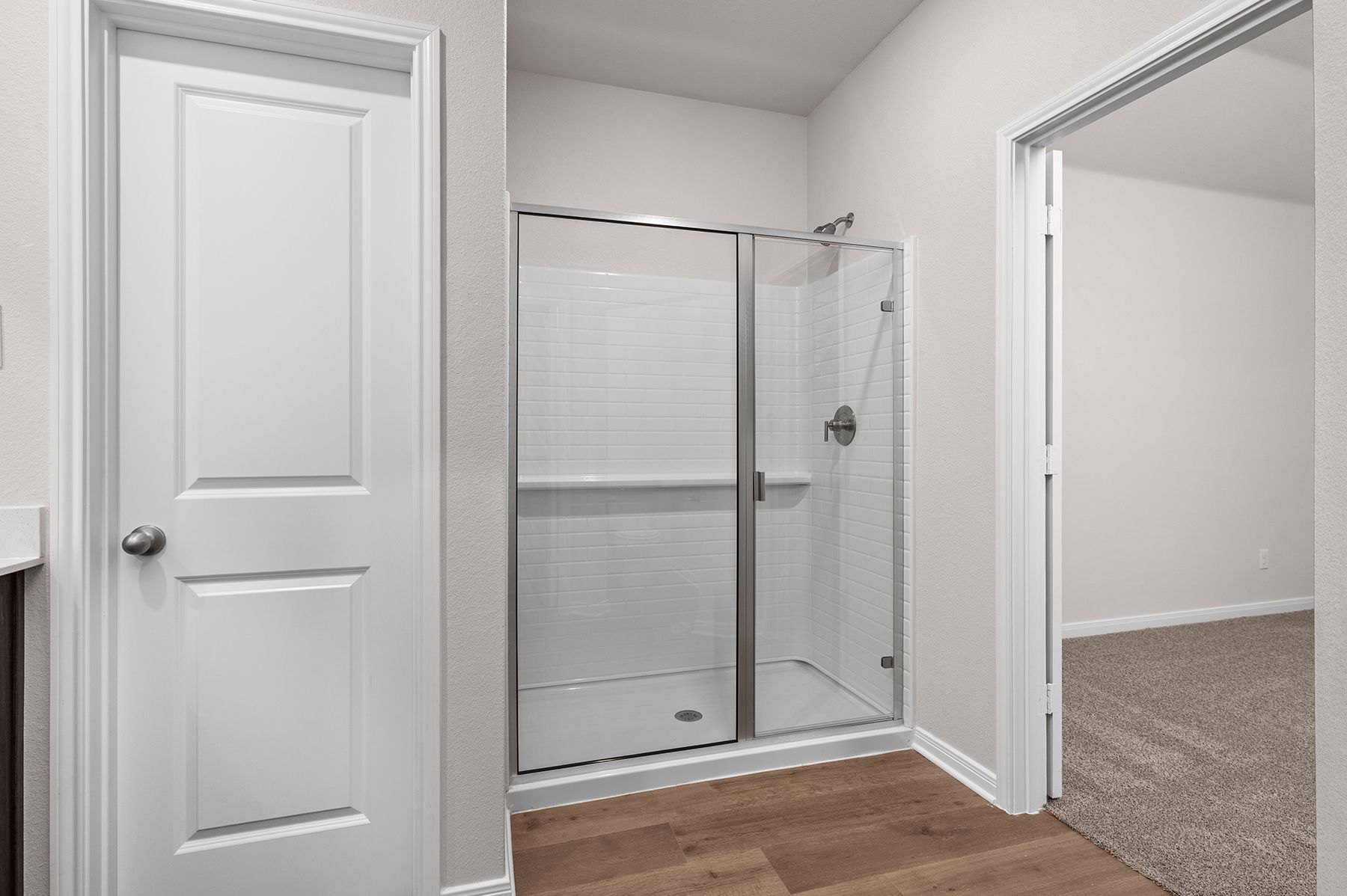 The master bathroom has a glass, walk-in shower.