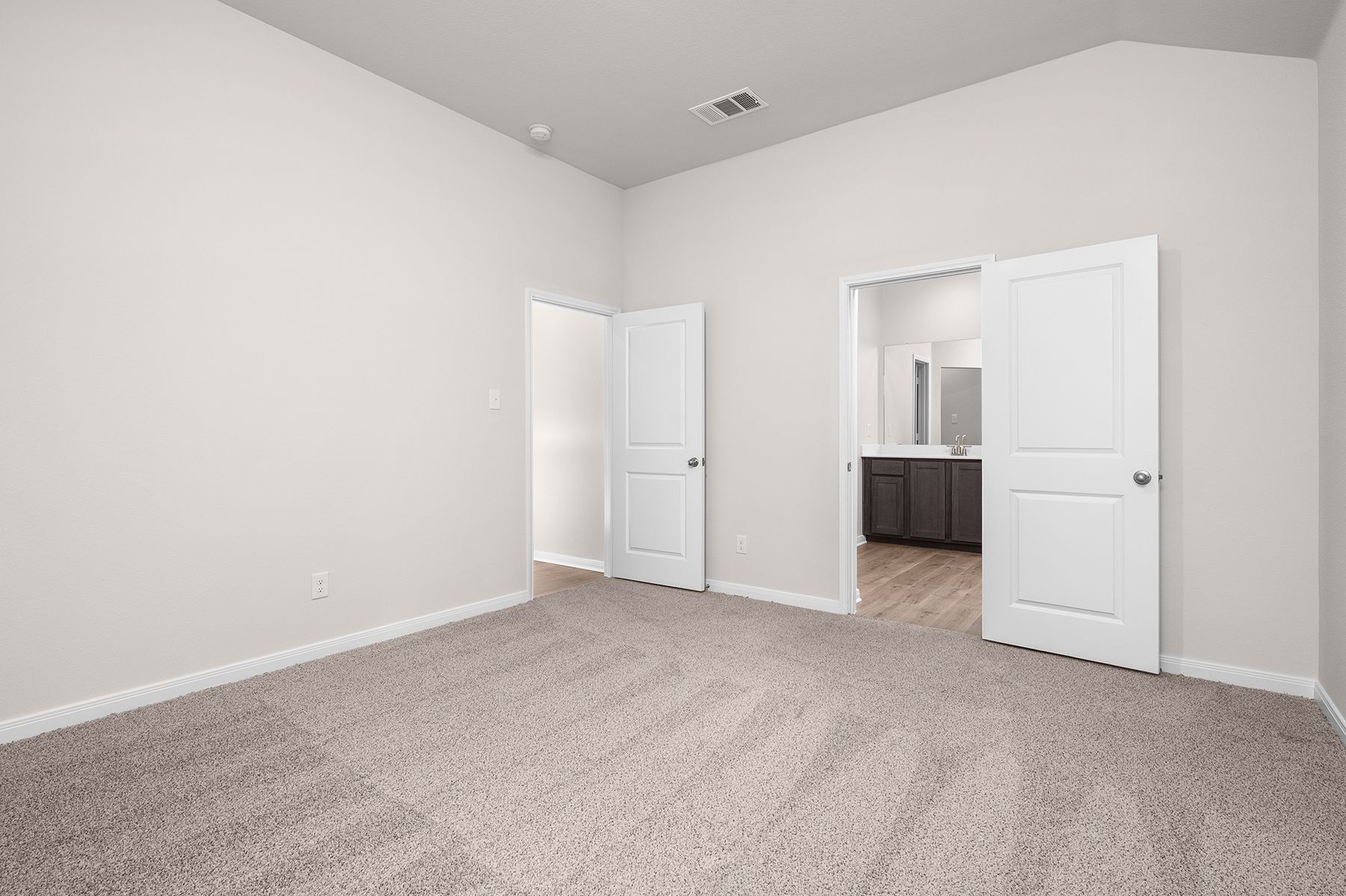 The master suite has a large bedroom, ensuite bathroom and a walk-in closet.