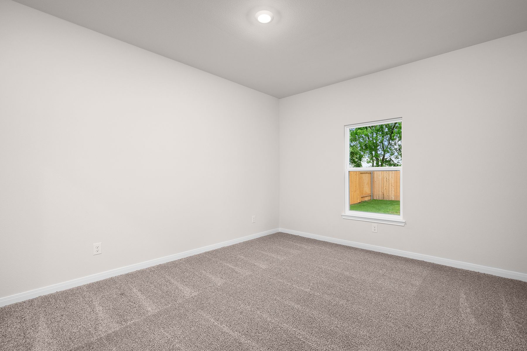 The master bedrooms is spacious and has a large window.