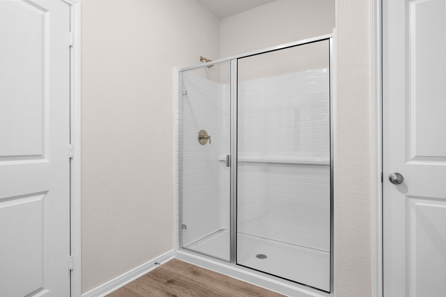 The master bathroom has a glass walk-in shower.