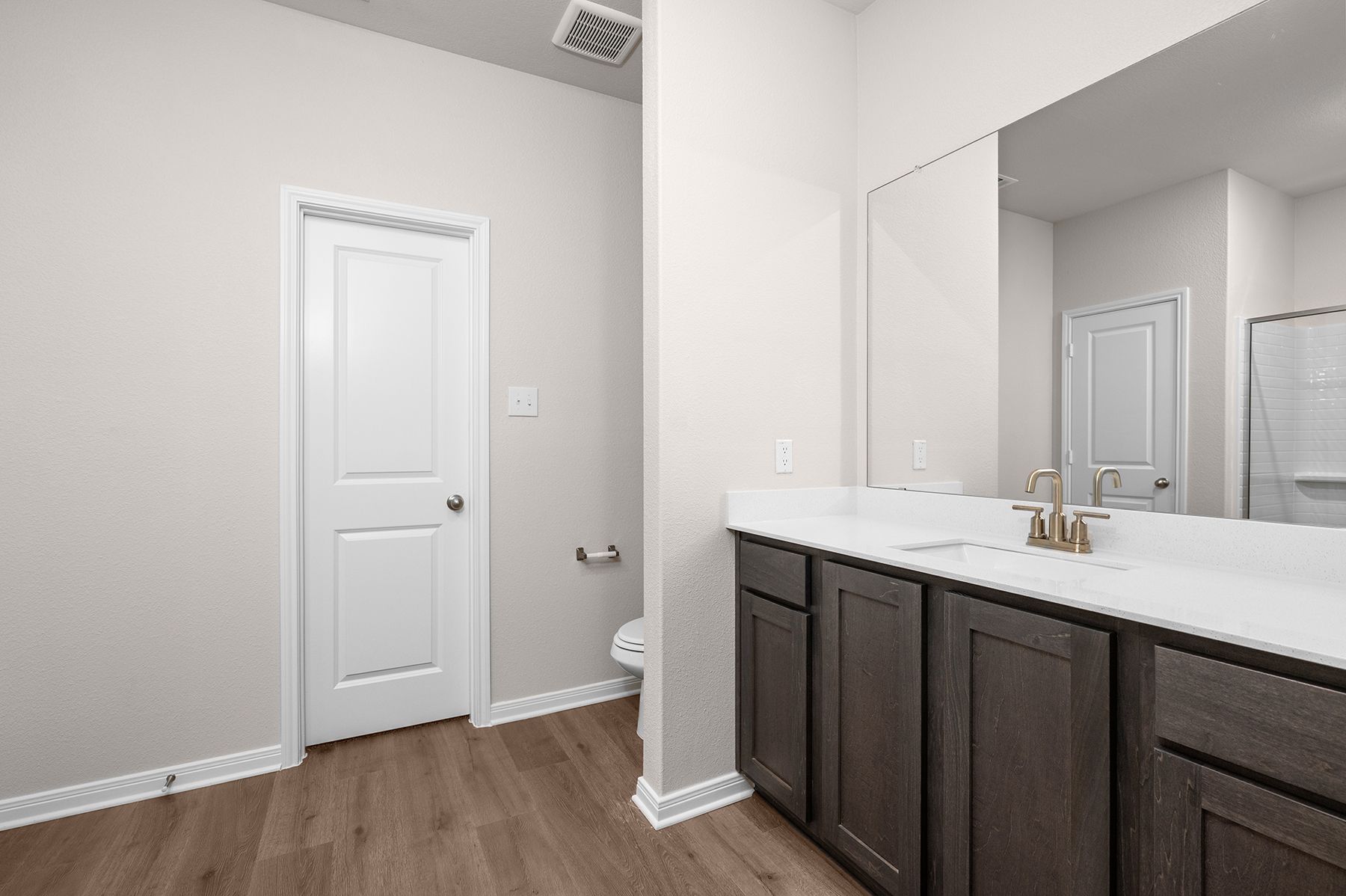 The master bathroom has a spacious vanity.