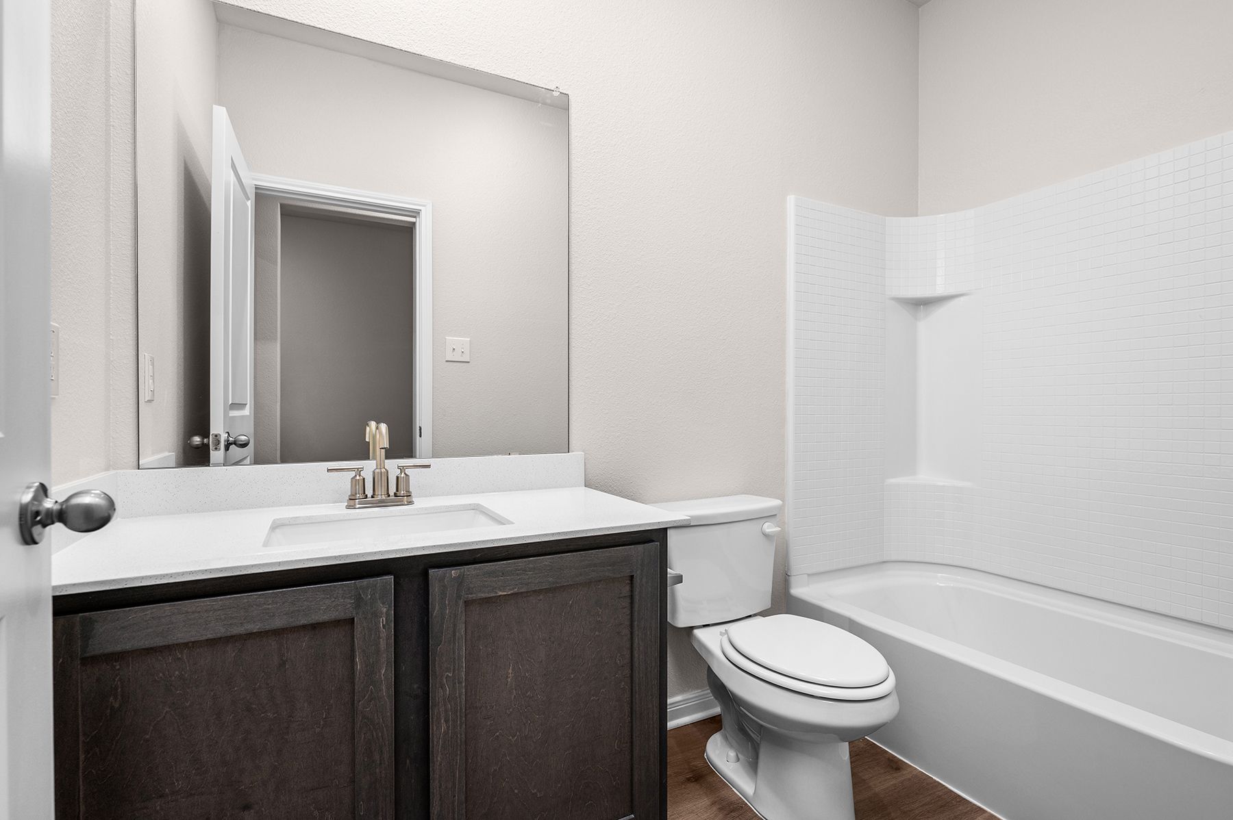 The secondary bathroom has a spacious vanity and shower-tub combo.