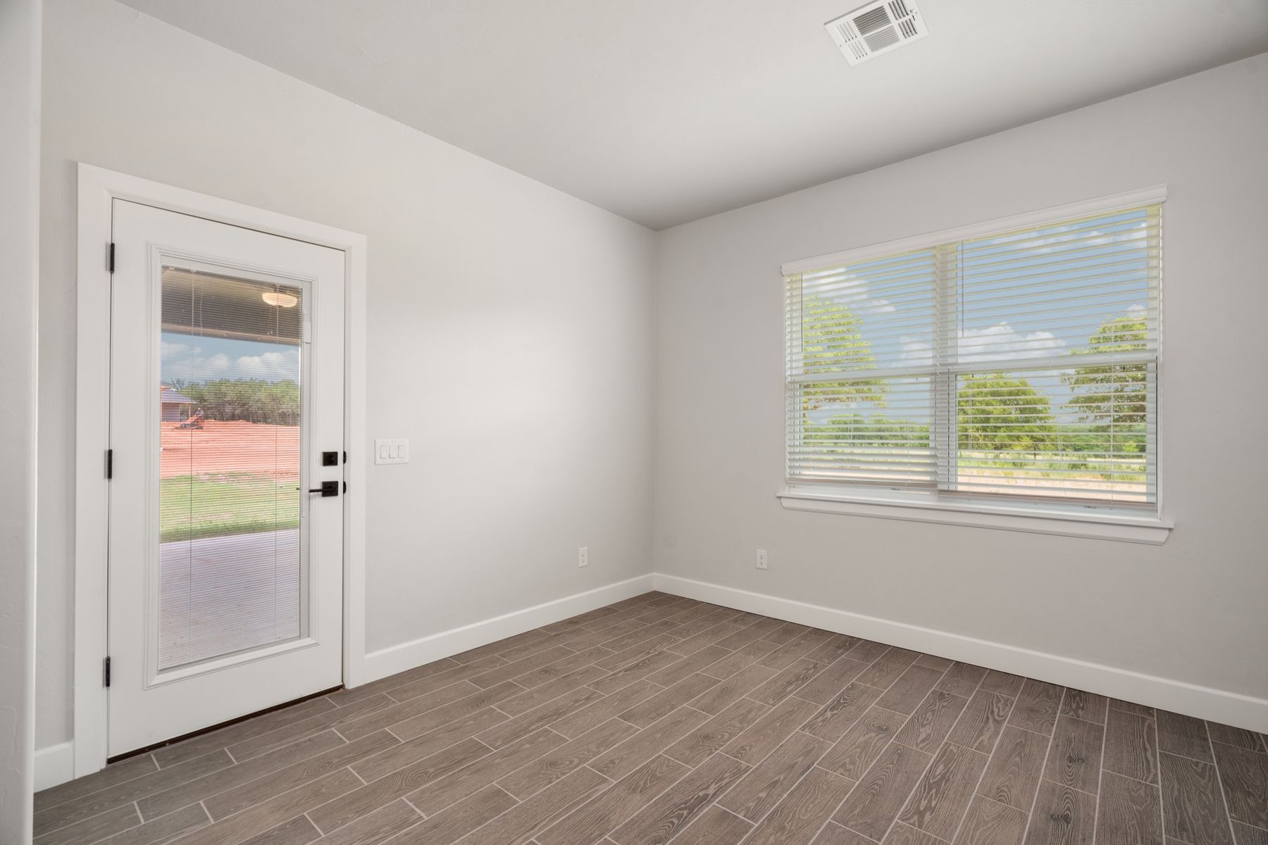The dining room has large windows that let in great, natural light.