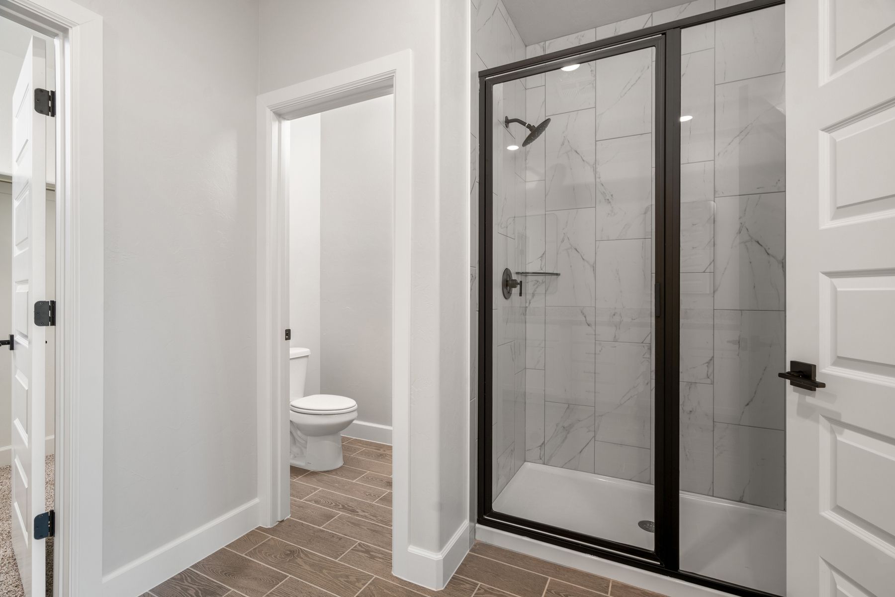 The master bathroom has a glass, walk-in shower and private toilet room.