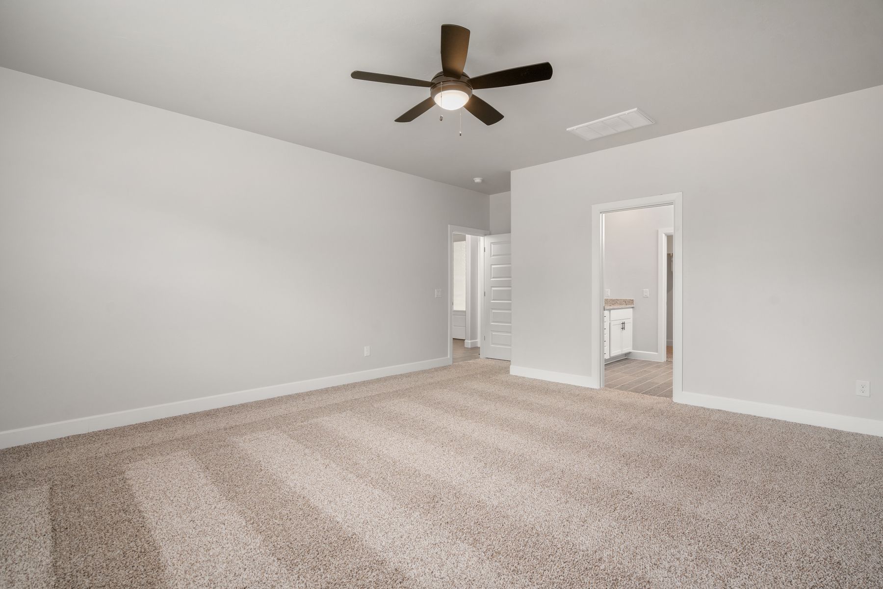 The master suite has a large bedroom, ensuite bathroom and a walk-in closet.