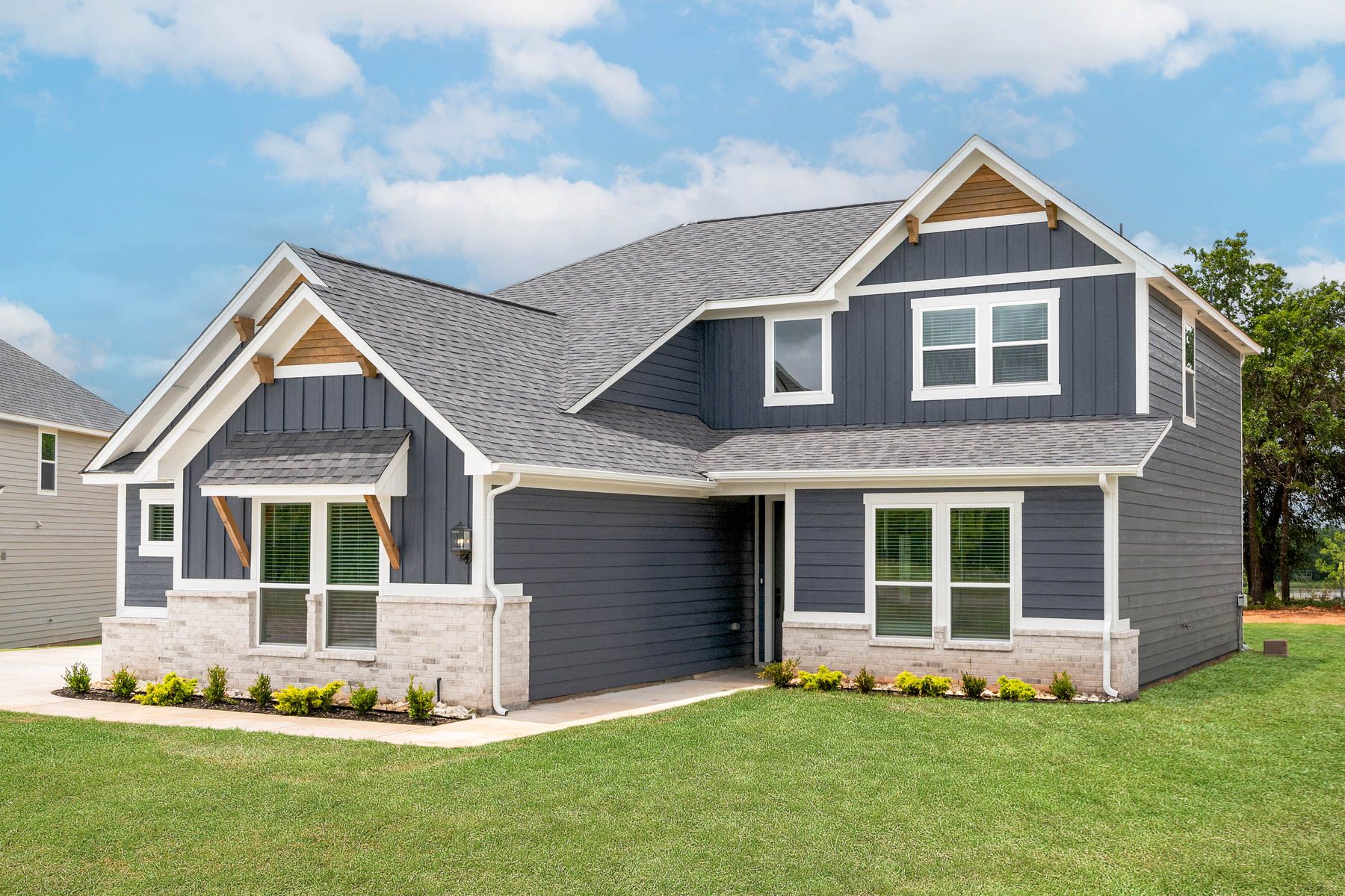 The Nicklaus is a beautiful two-story siding home with stone detailing.