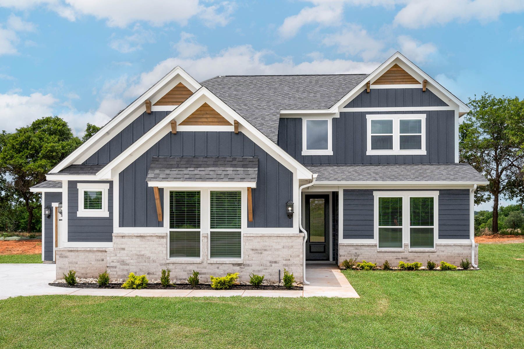The Nicklaus is a beautiful two-story siding home with stone detailing.